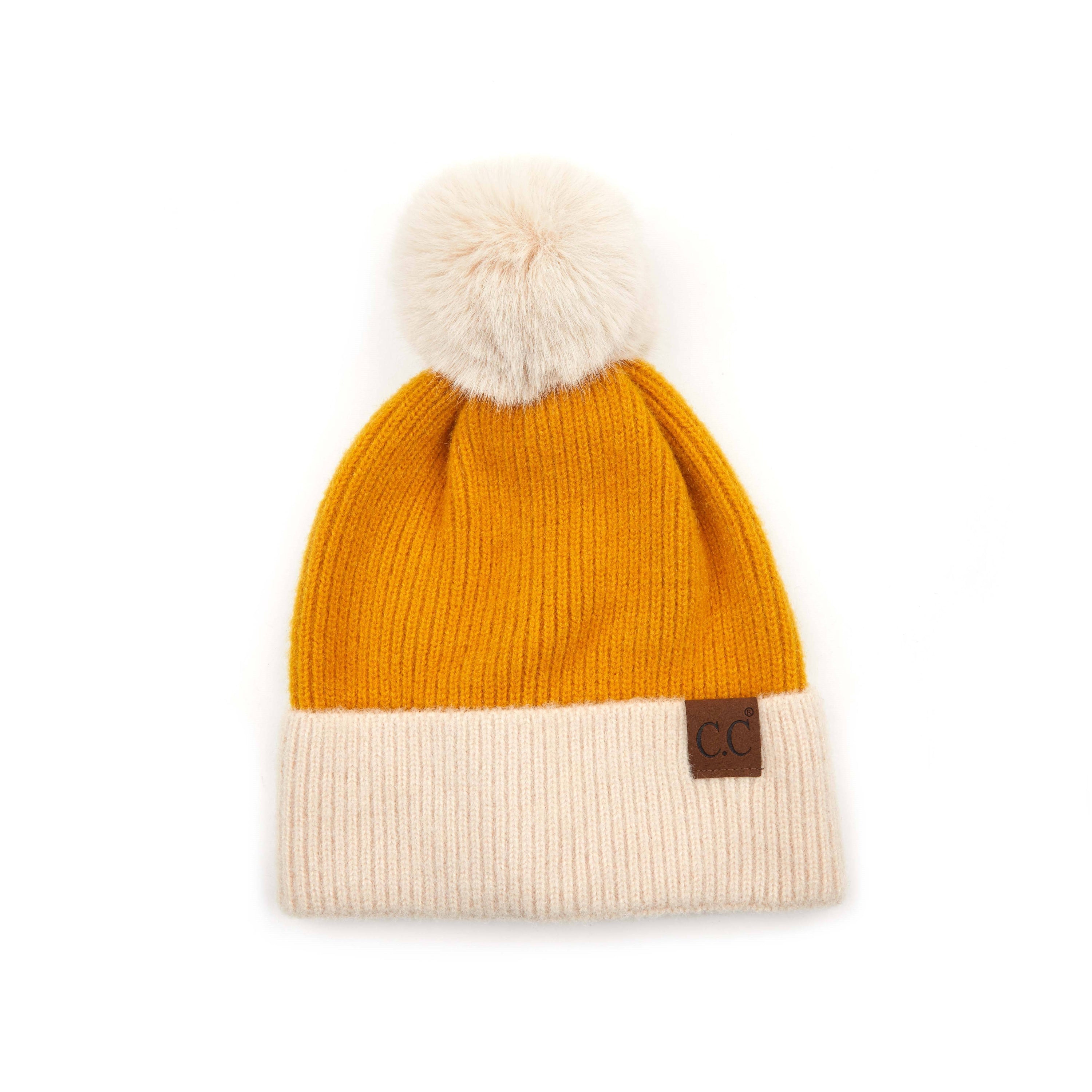 CC Festive Beanie featuring a faux fur pom and metallic detail, perfect for winter style.