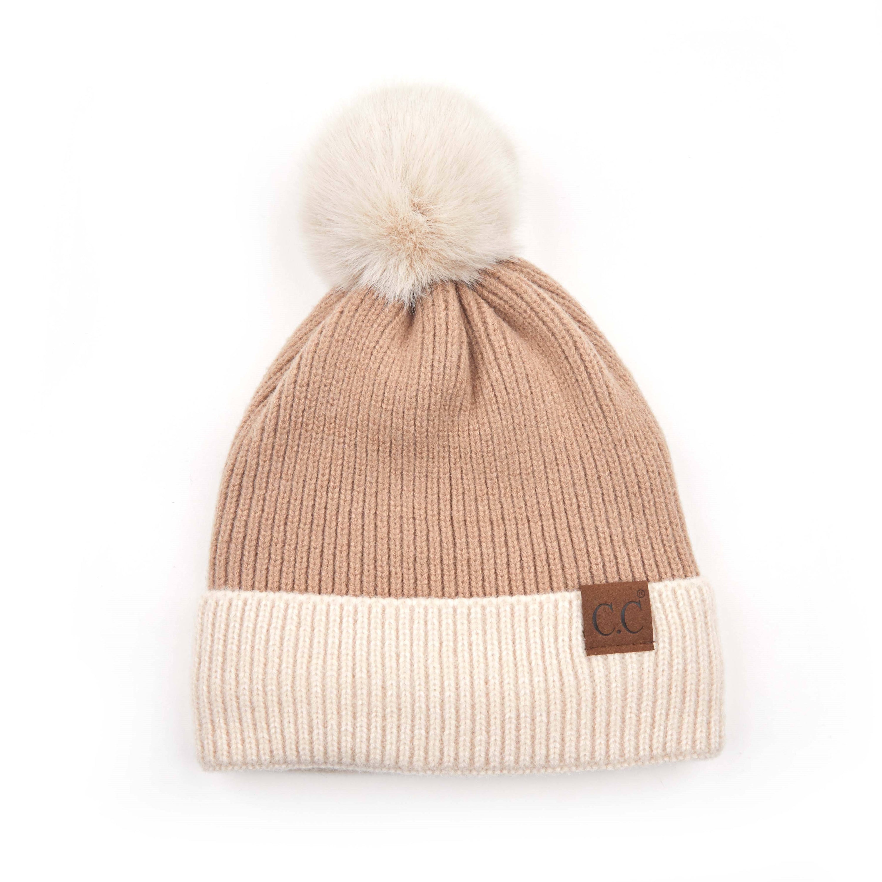 CC Festive Beanie featuring a faux fur pom and metallic detail, perfect for winter style.