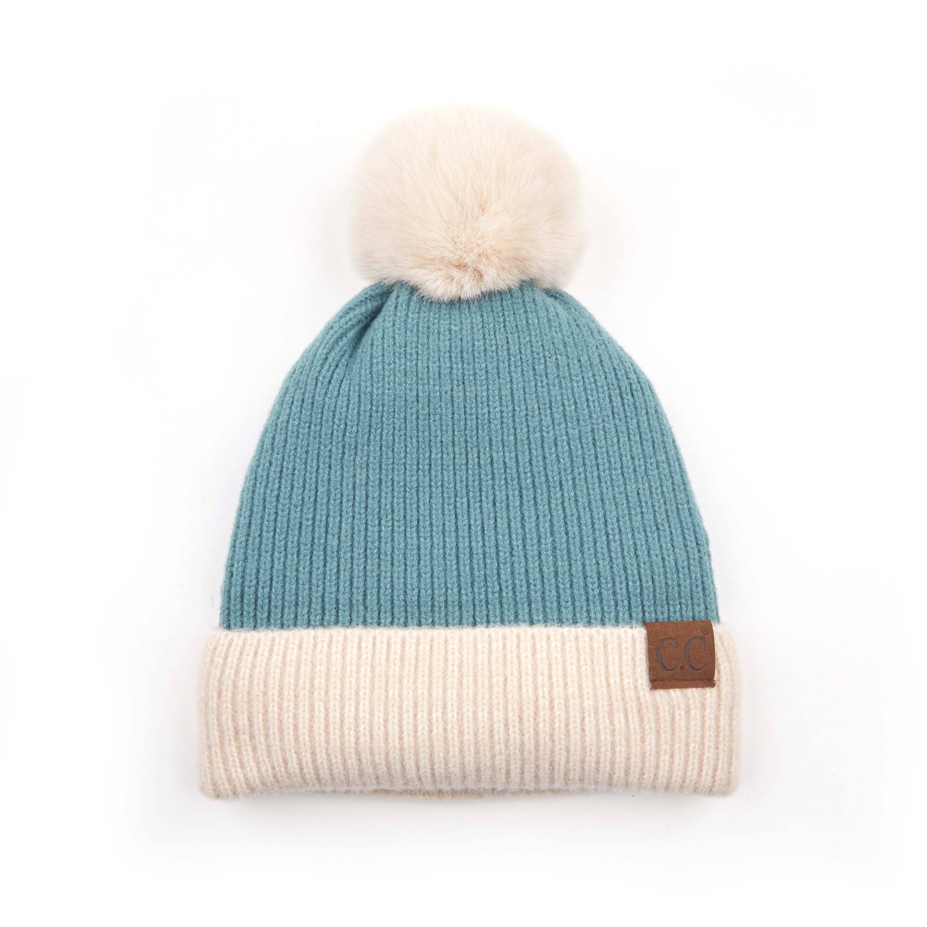 CC Festive Beanie featuring a faux fur pom and metallic detail, perfect for winter style.