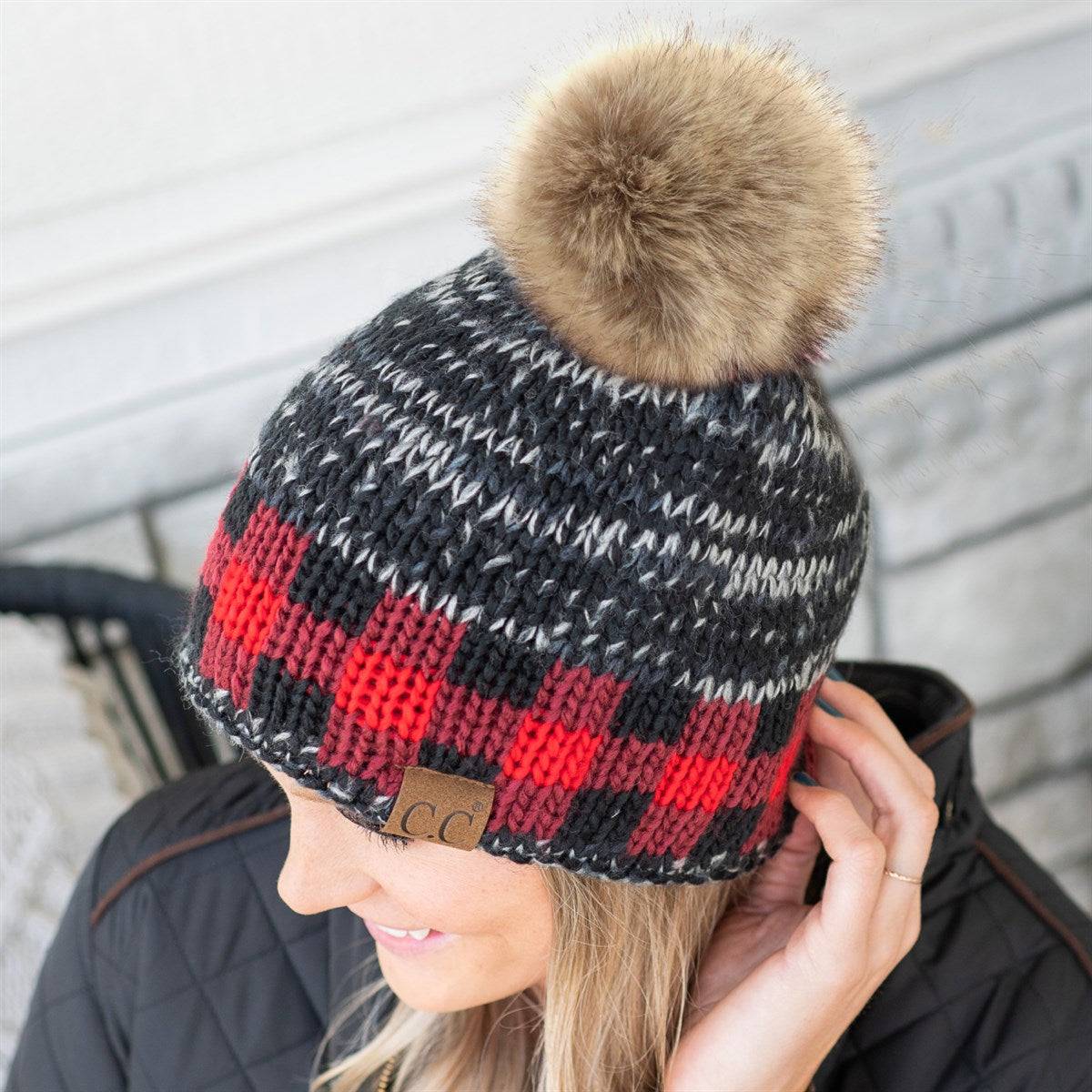 CC Fire Cozy Buffalo Plaid Beanie featuring a faux fur pom and stylish buffalo plaid design, perfect for winter wear.