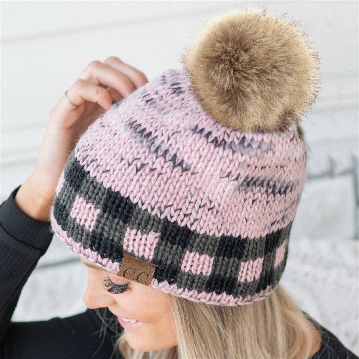 CC Fire Cozy Buffalo Plaid Beanie featuring a faux fur pom and stylish buffalo plaid design, perfect for winter wear.