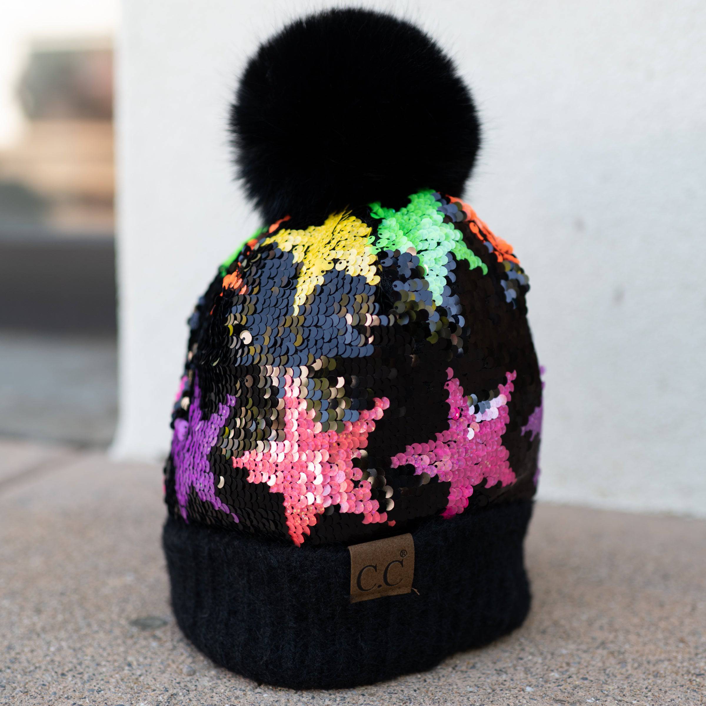 CC Kids Neon Star Sequin Faux Fur Pom Beanie featuring a vibrant sequin design and a fluffy faux fur pom on top.