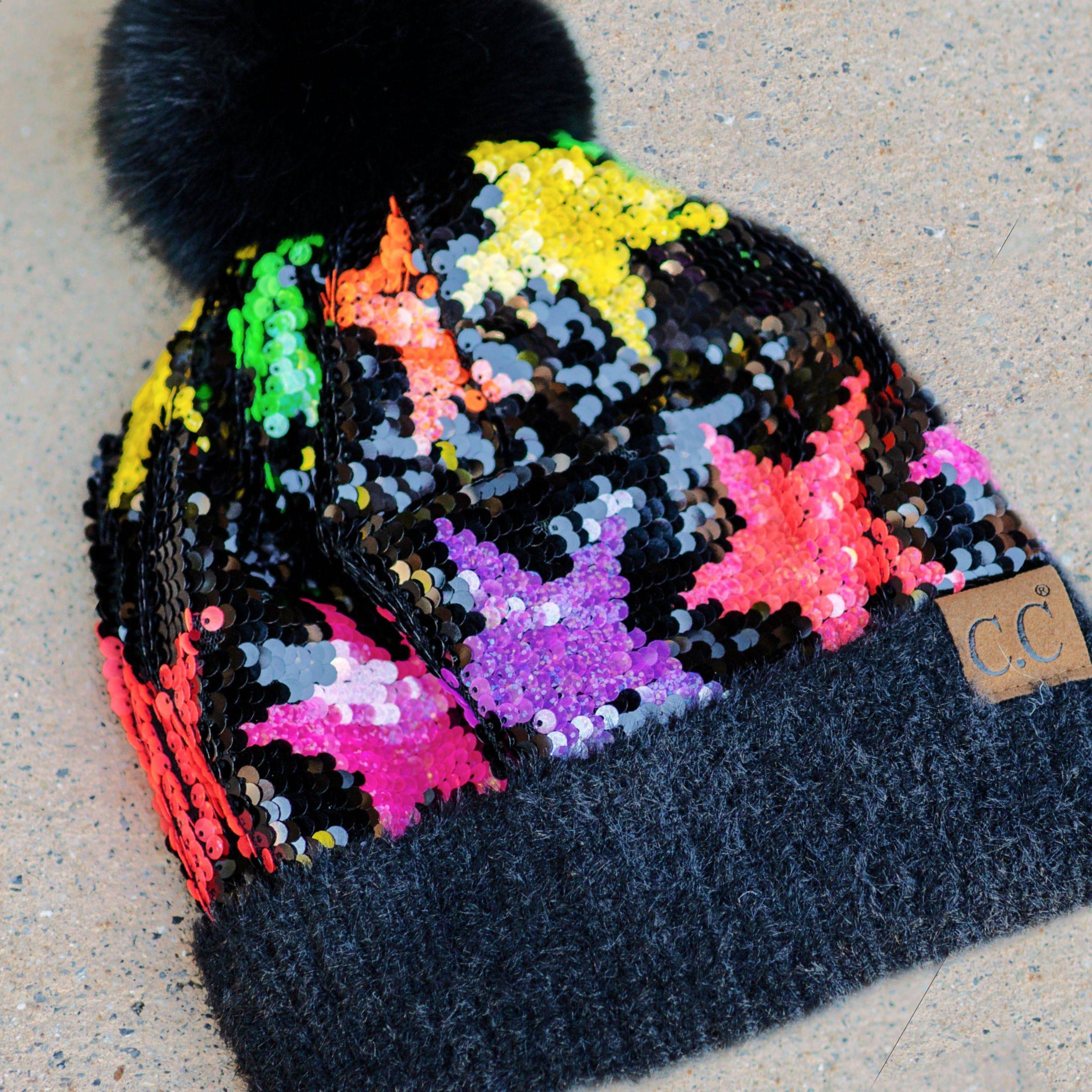 CC Kids Neon Star Sequin Faux Fur Pom Beanie featuring a vibrant sequin design and a fluffy faux fur pom on top.