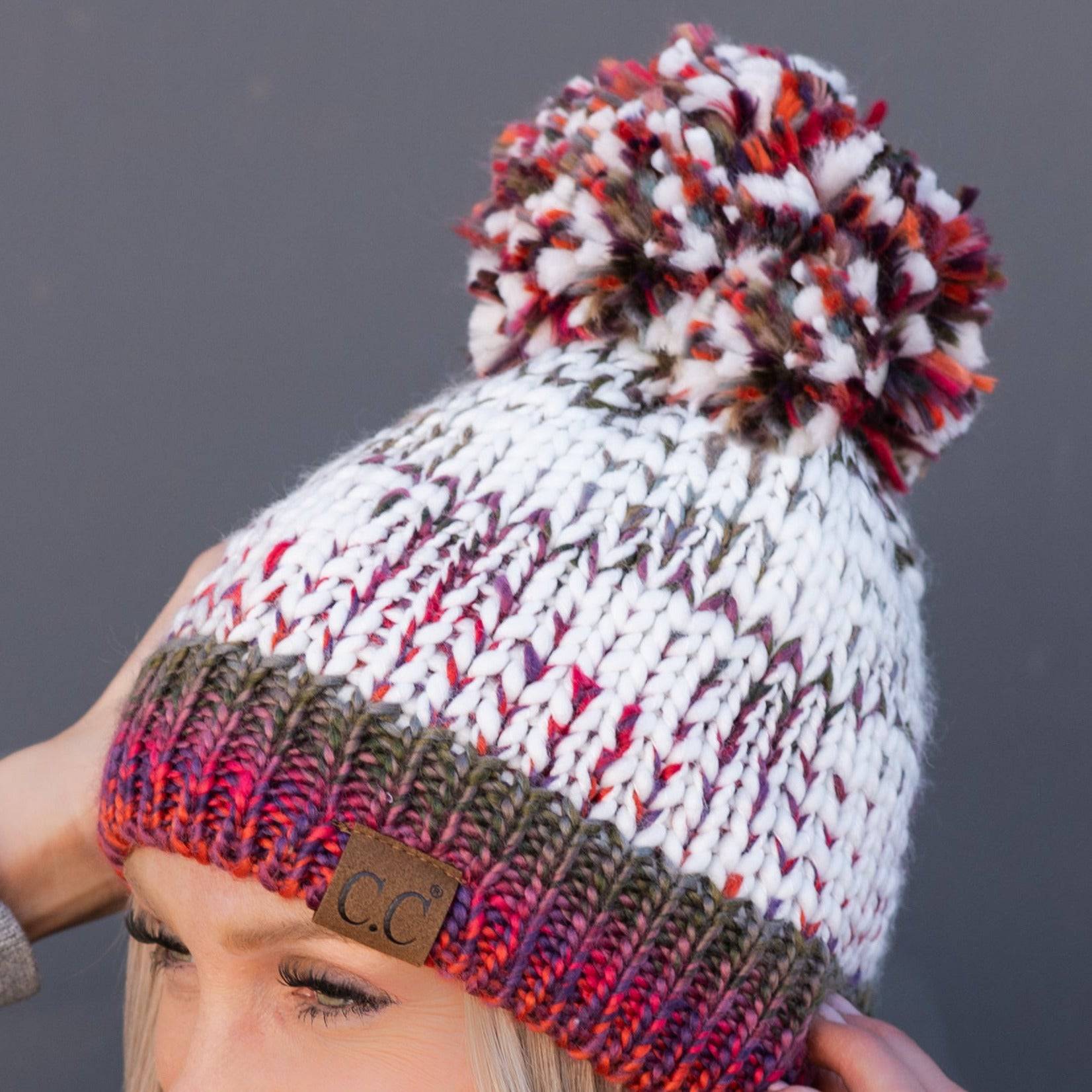 CC Multi-Color Yarn Beanie with Pom, featuring vibrant colors and a soft lining, perfect for winter wear.