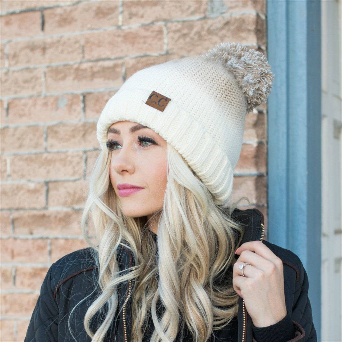 CC Ombre Beanie featuring a trendy ombre pattern and yarn pom, fleece lined for warmth and comfort.