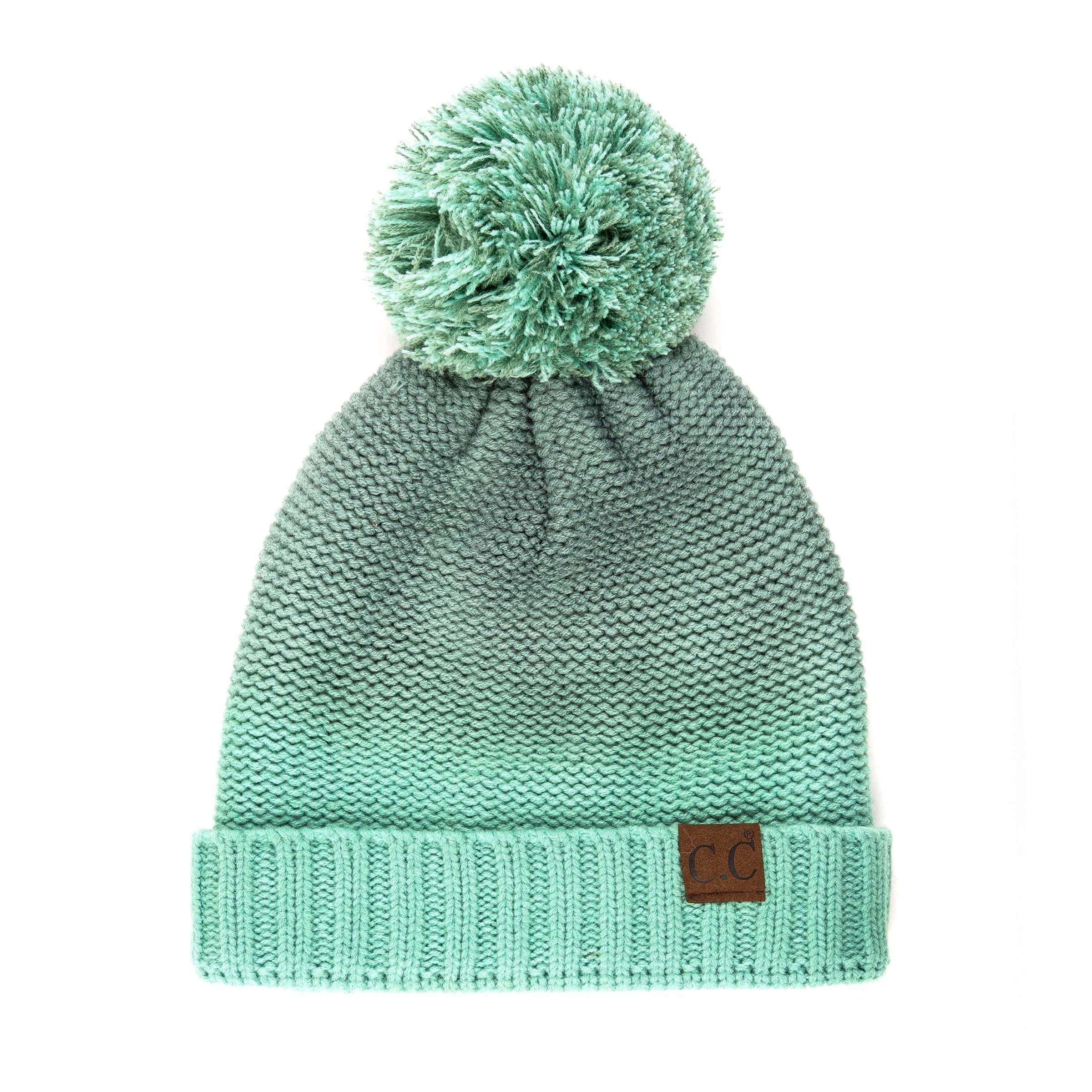 CC Ombre Beanie featuring a trendy ombre pattern and yarn pom, fleece lined for warmth and comfort.