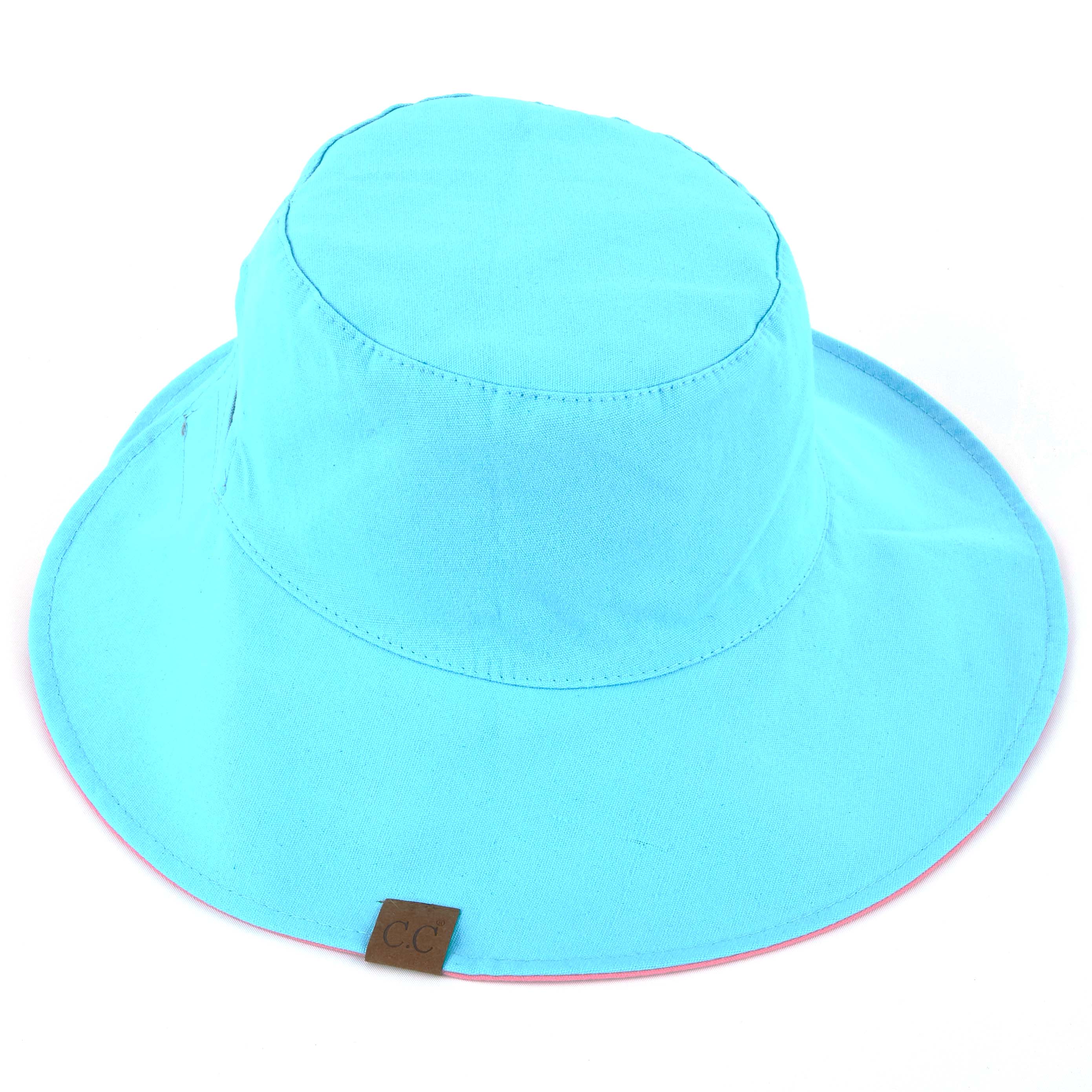 CC Reversible Ponytail Bucket Hat in two colors, featuring a ponytail opening and adjustable closure, perfect for sun protection.