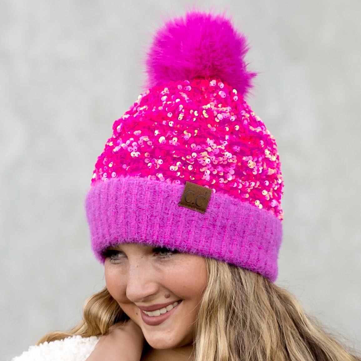 CC Sequin Fur Pom Beanie featuring a sparkling sequin design and a plush faux fur pom, available in adult and kid sizes.