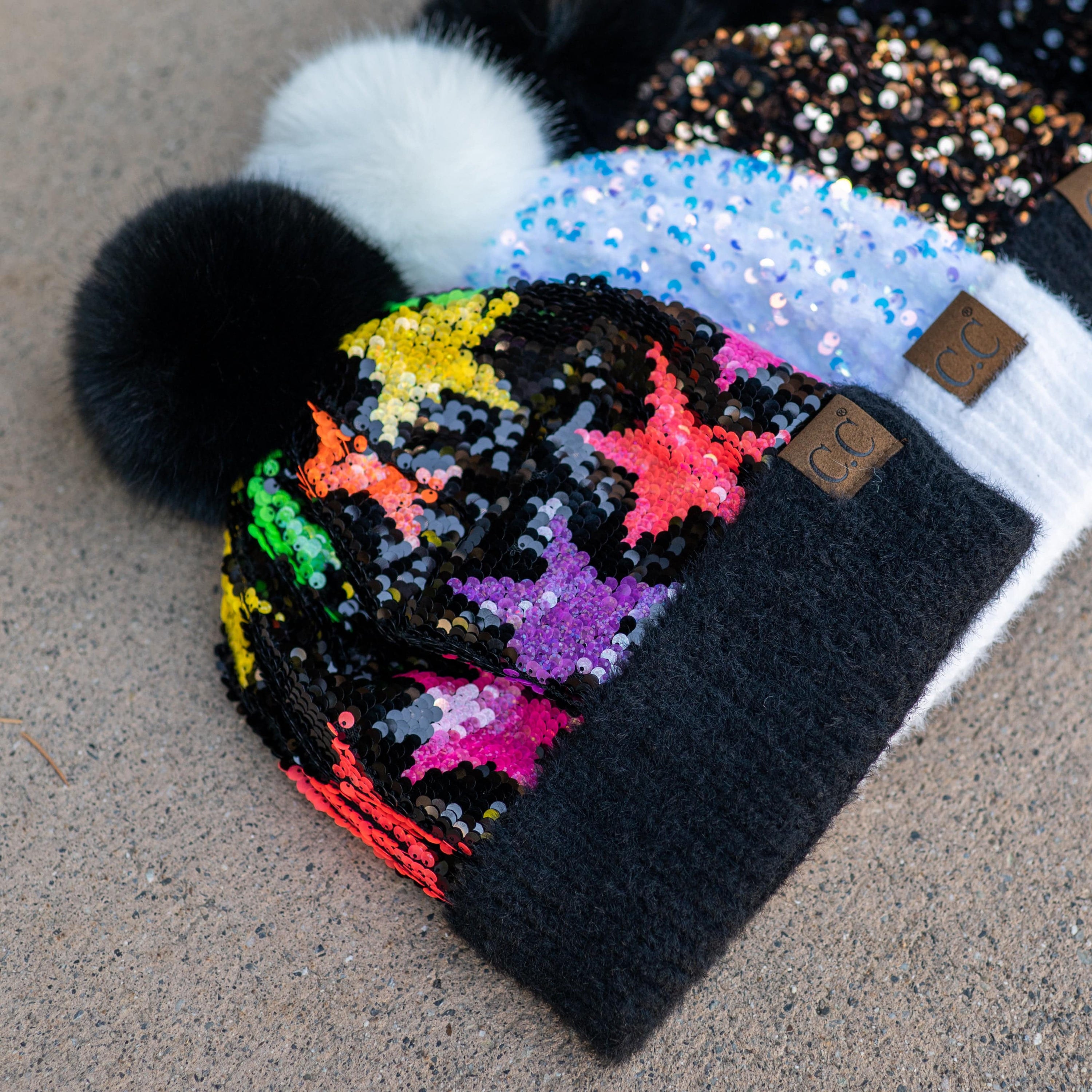 CC Sequin Fur Pom Beanie featuring a sparkling sequin design and a plush faux fur pom, available in adult and kid sizes.