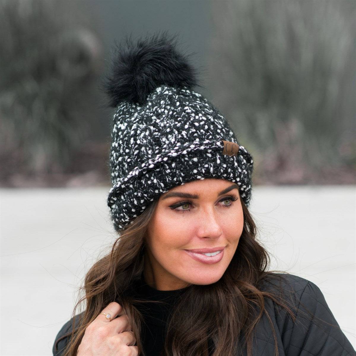 CC Speck Lined Beanie featuring a faux fur pom and speck pattern, perfect for cold weather wear.