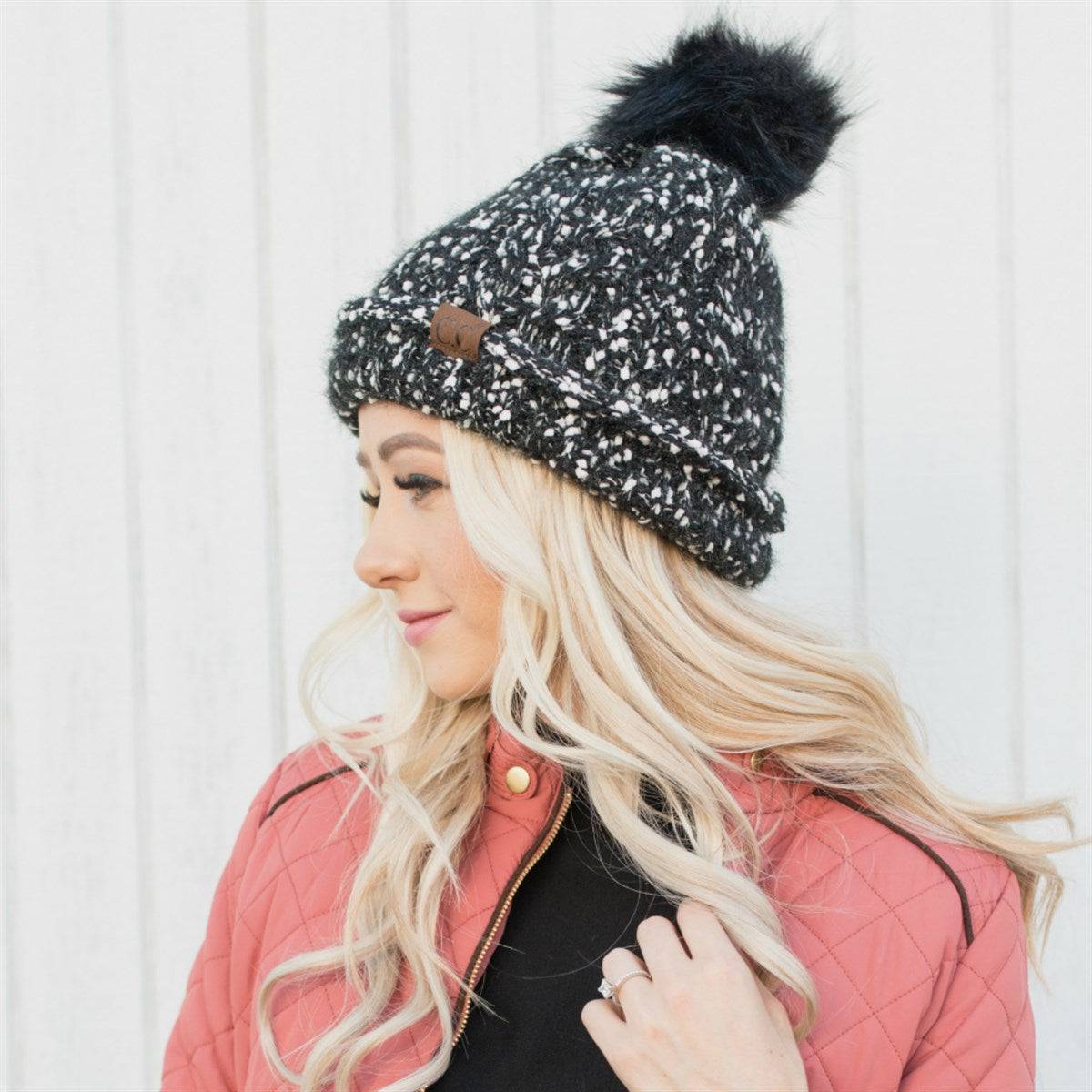 CC Speck Lined Beanie featuring a faux fur pom and speck pattern, perfect for cold weather wear.