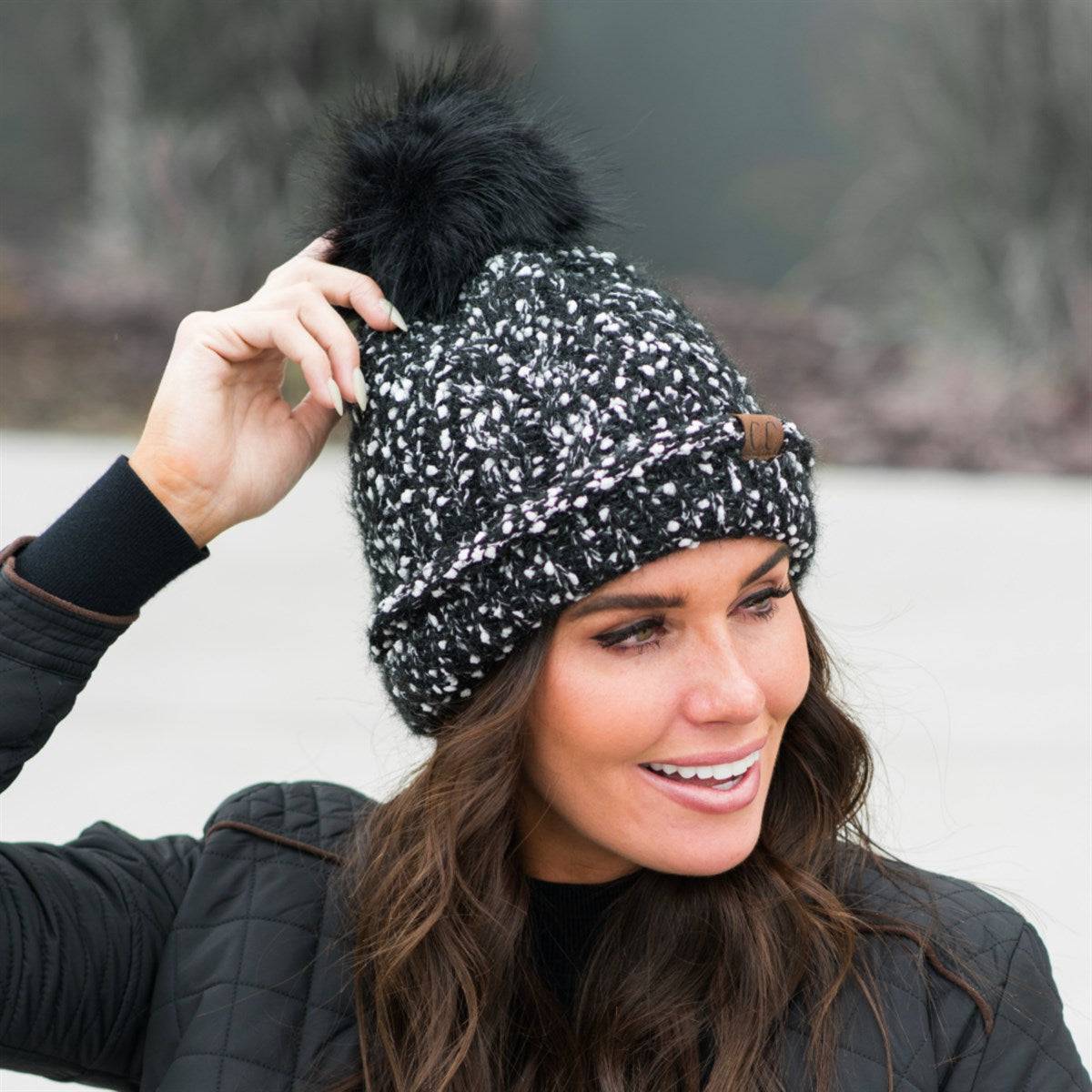 CC Speck Lined Beanie featuring a faux fur pom and speck pattern, perfect for cold weather wear.