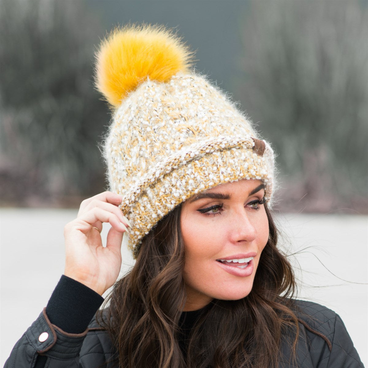 CC Speck Lined Beanie featuring a faux fur pom and speck pattern, perfect for cold weather wear.