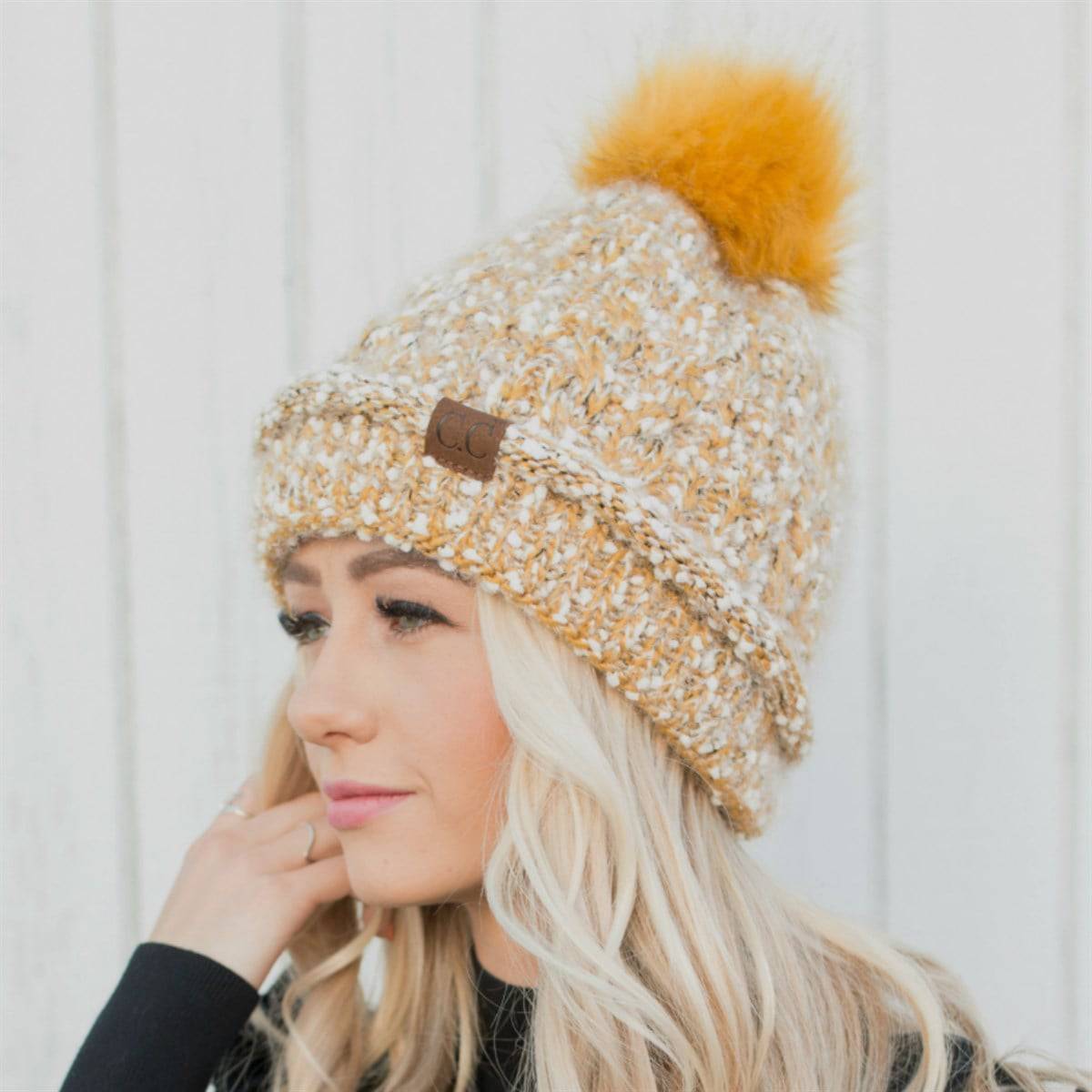 CC Speck Lined Beanie featuring a faux fur pom and speck pattern, perfect for cold weather wear.