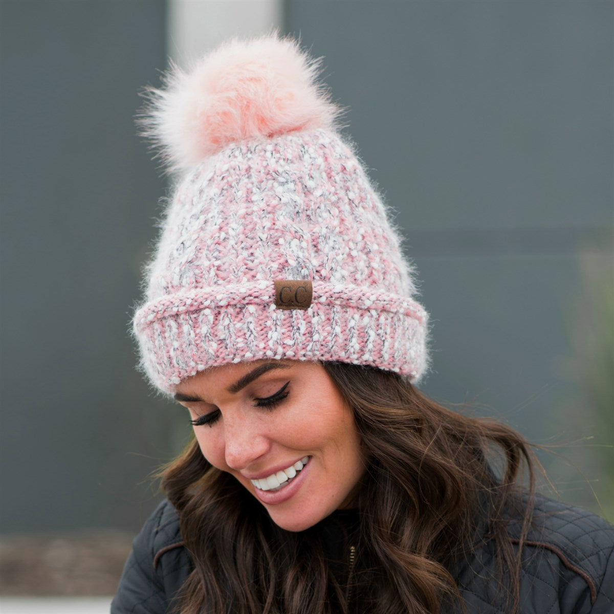 CC Speck Lined Beanie featuring a faux fur pom and speck pattern, perfect for cold weather wear.