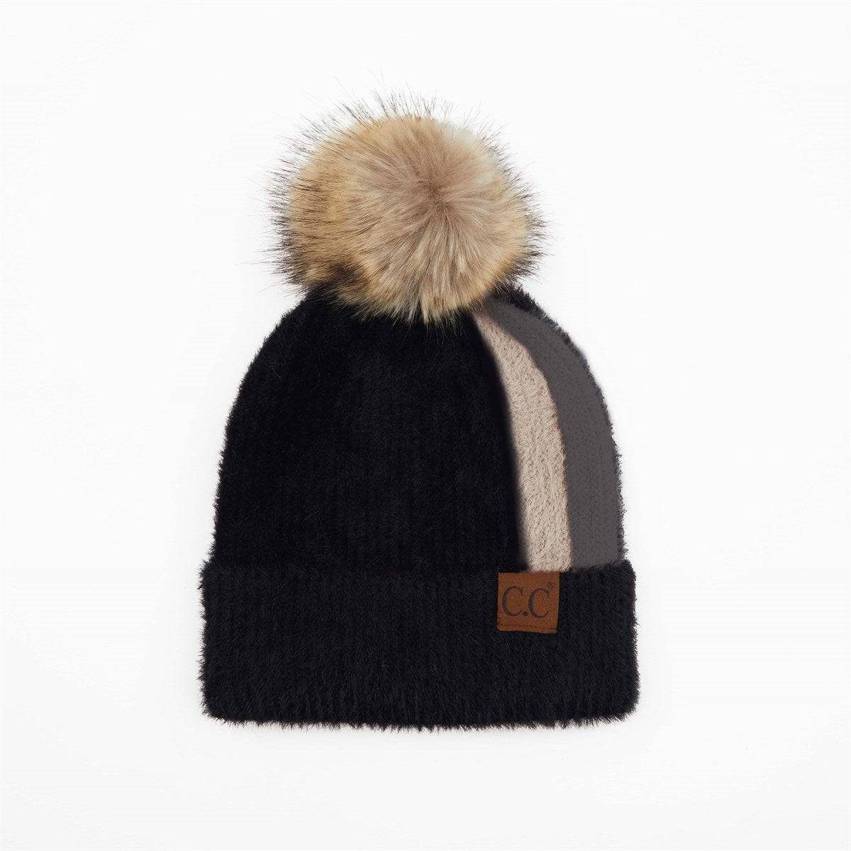 CC Sport Stripe Beanie featuring a soft faux fur pom-pom and stylish stripe design, perfect for winter wear.