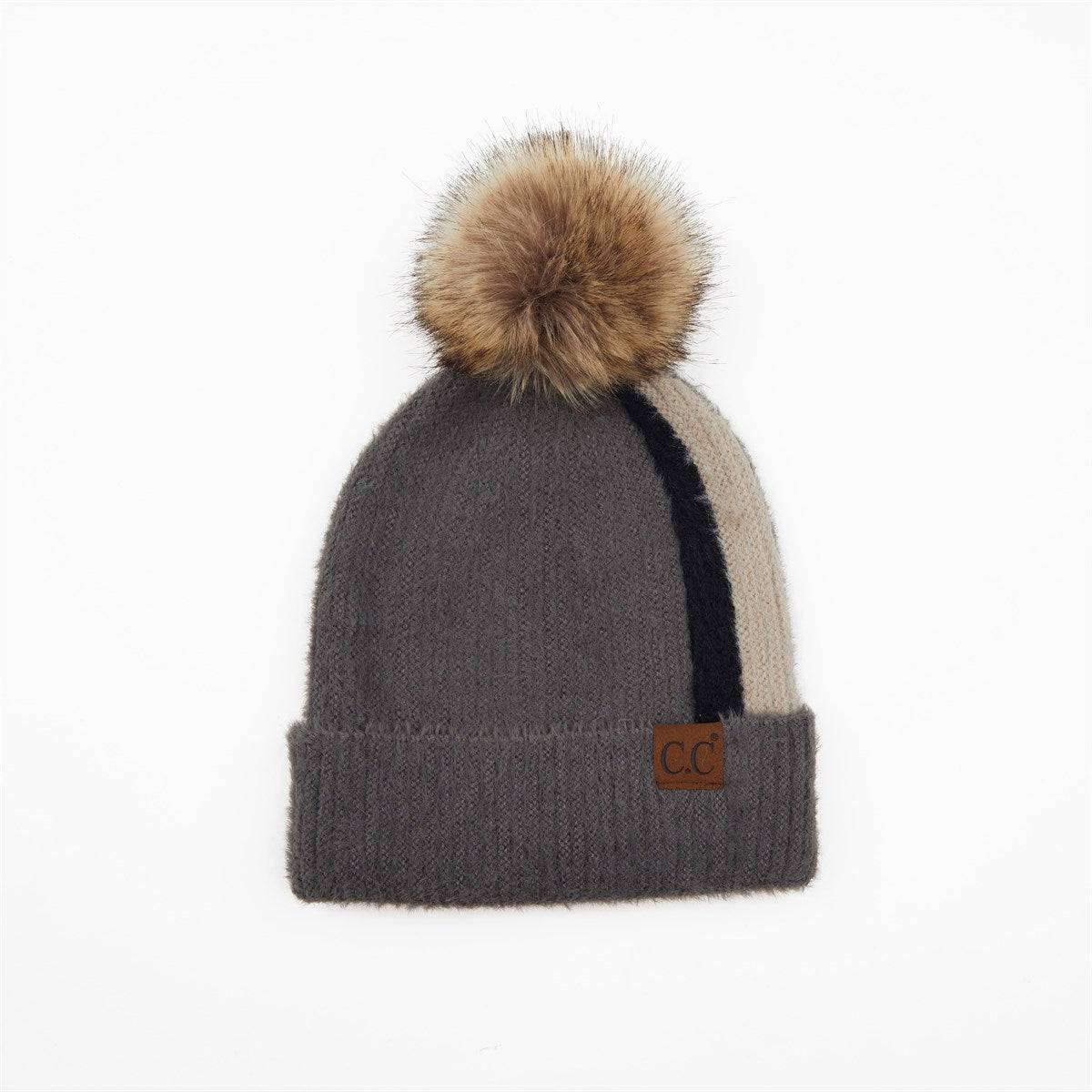 CC Sport Stripe Beanie featuring a soft faux fur pom-pom and stylish stripe design, perfect for winter wear.