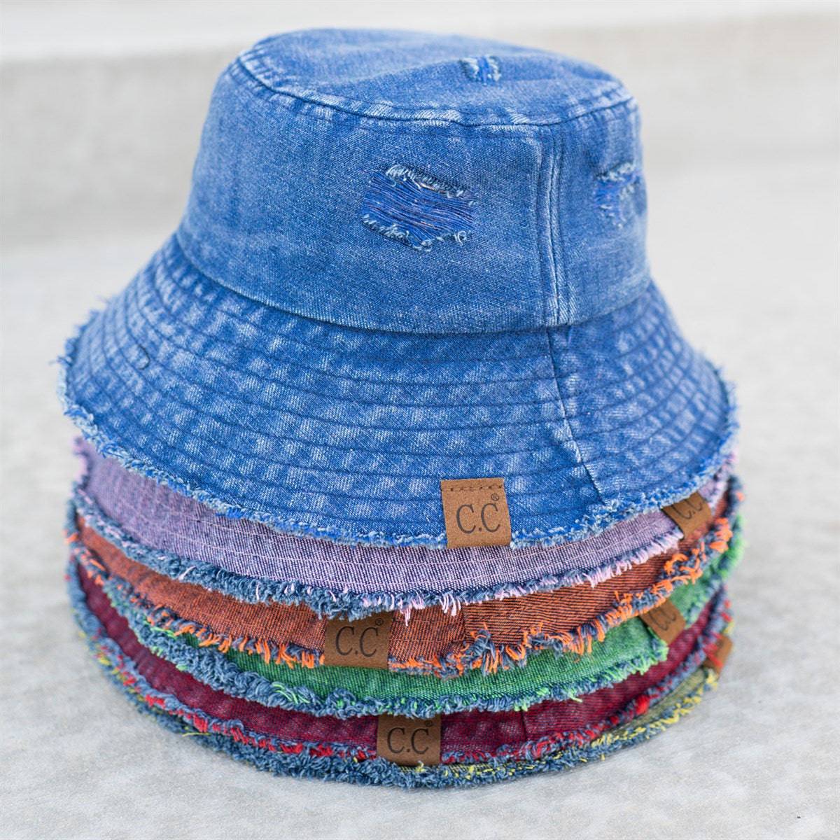 CC Stone Washed Denim Bucket hat with adjustable inner band, showcasing a trendy stone-wash finish, perfect for outdoor activities.