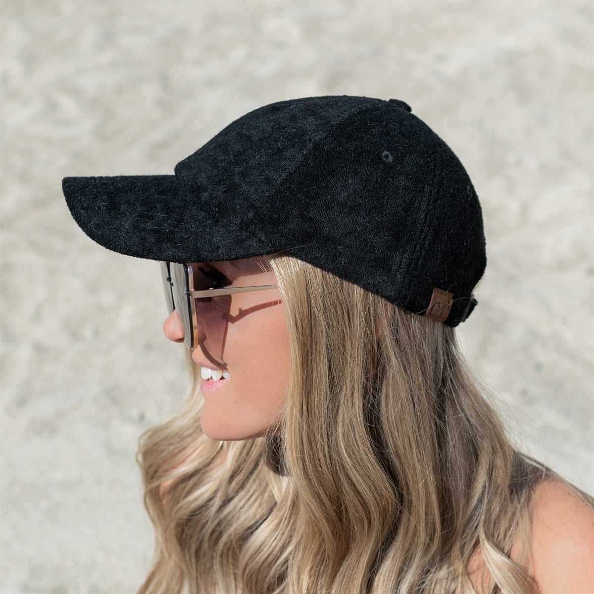 CC Terry Cloth Women Baseball Trucker Cap featuring a low ponytail opening, adjustable velcro back, and soft terry cloth material.