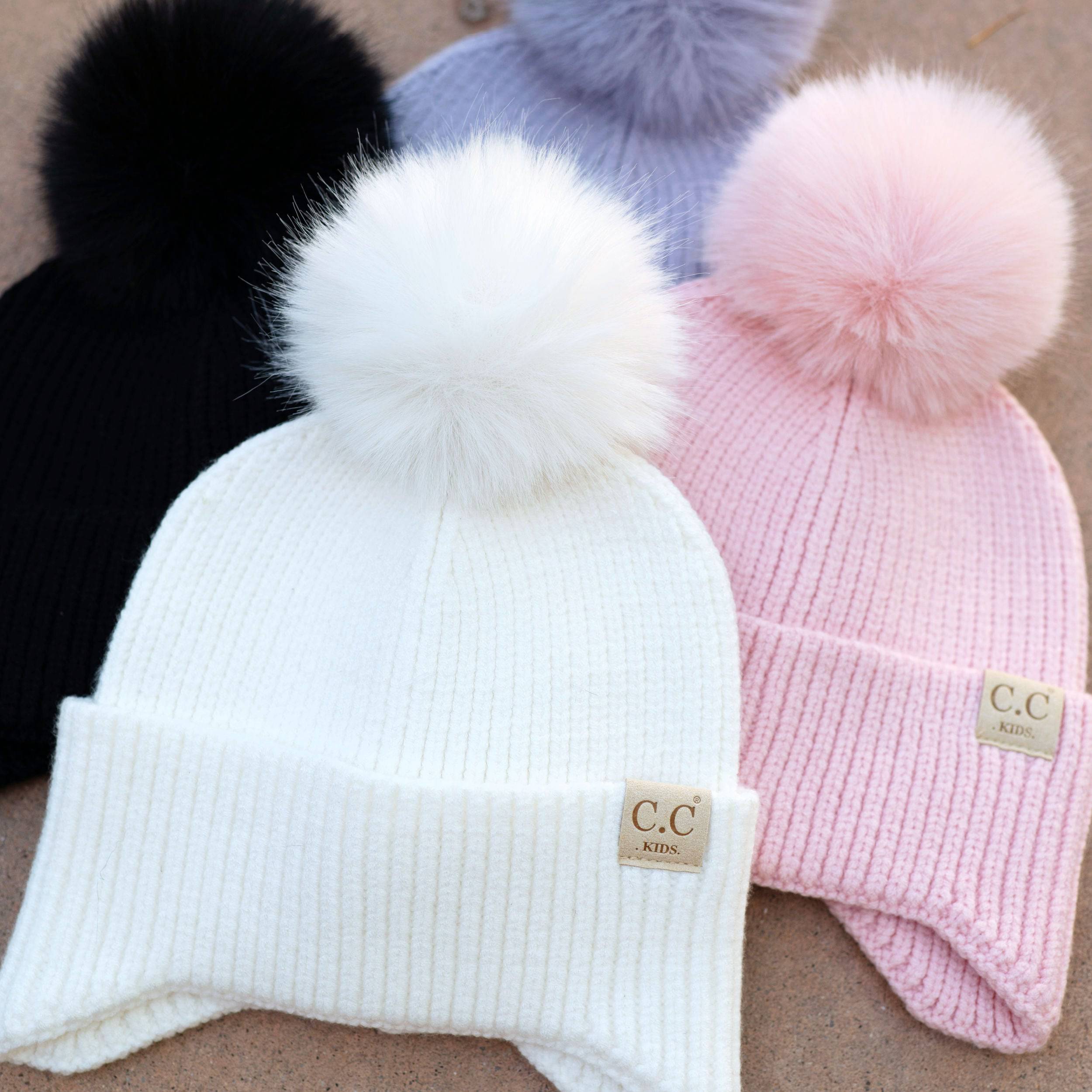 CC Toasty and Warm Pom Ear Flap Kids Beanie with double faux fur pom pom and ear flaps, designed for warmth and comfort.