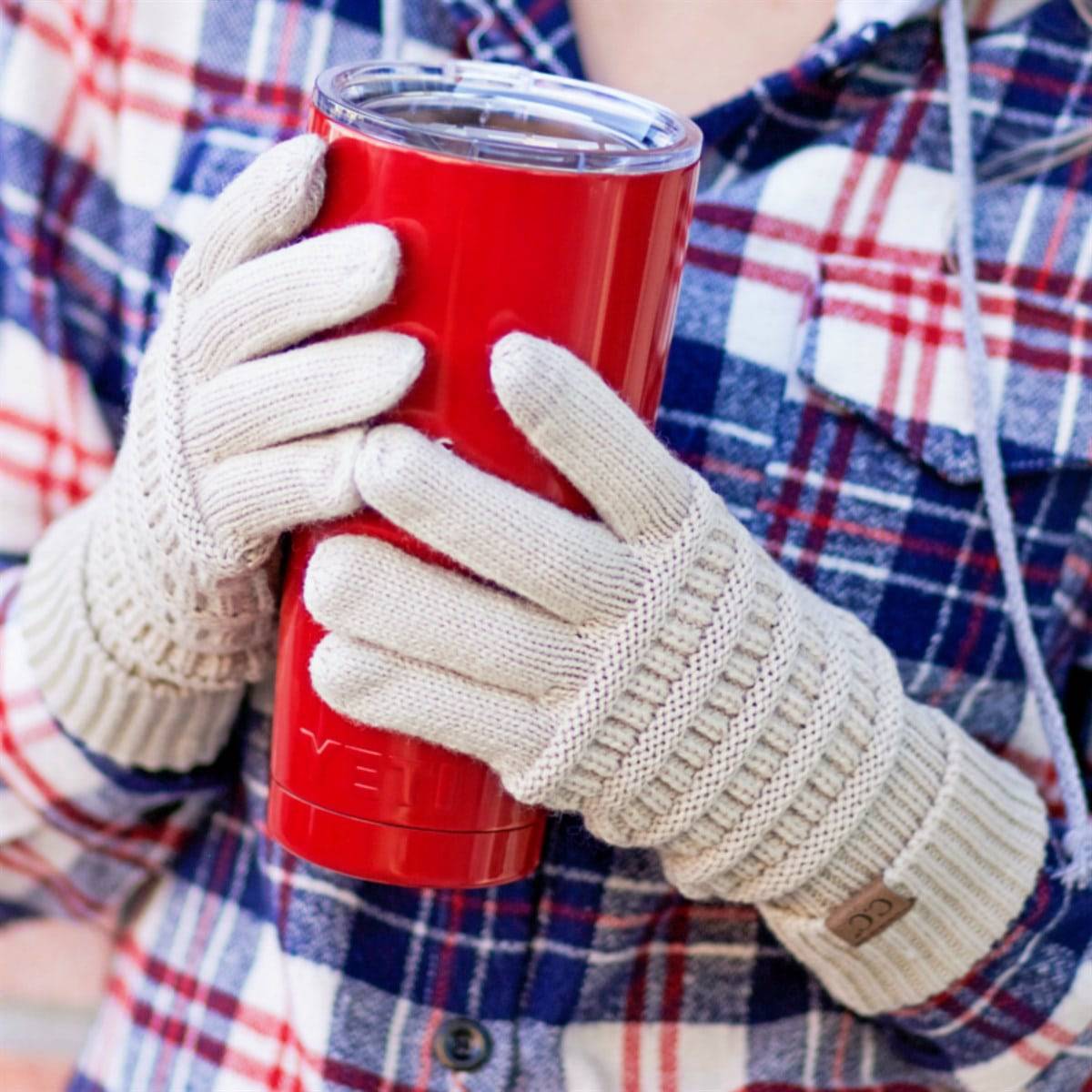 A pair of stylish CC Touchscreen Gloves in a cable knit pattern, designed for smartphone use with soft acrylic material.