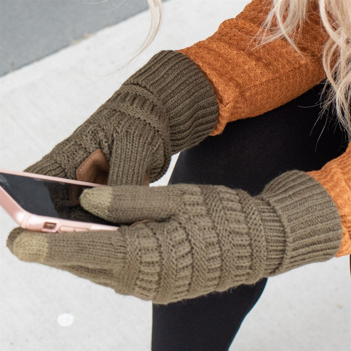 A pair of stylish CC Touchscreen Gloves in a cable knit pattern, designed for smartphone use with soft acrylic material.