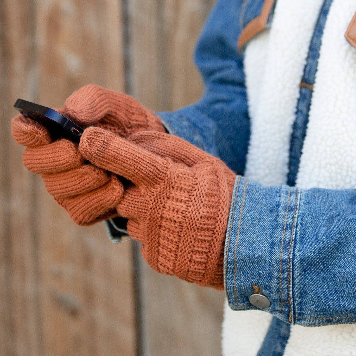 A pair of stylish CC Touchscreen Gloves in a cable knit pattern, designed for smartphone use with soft acrylic material.