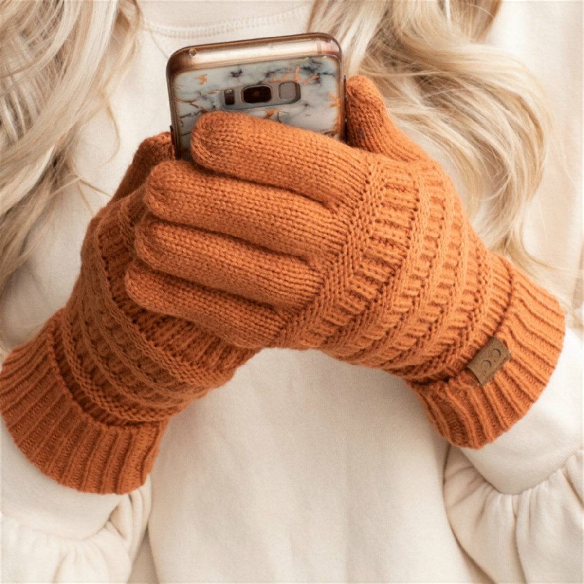 A pair of stylish CC Touchscreen Gloves in a cable knit pattern, designed for smartphone use with soft acrylic material.