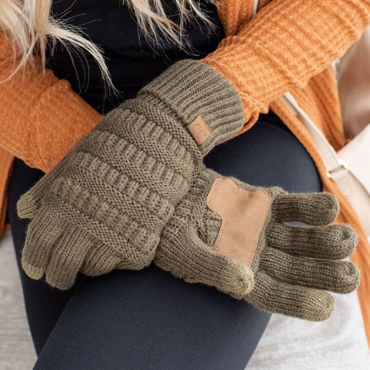 A pair of stylish CC Touchscreen Gloves in a cable knit pattern, designed for smartphone use with soft acrylic material.