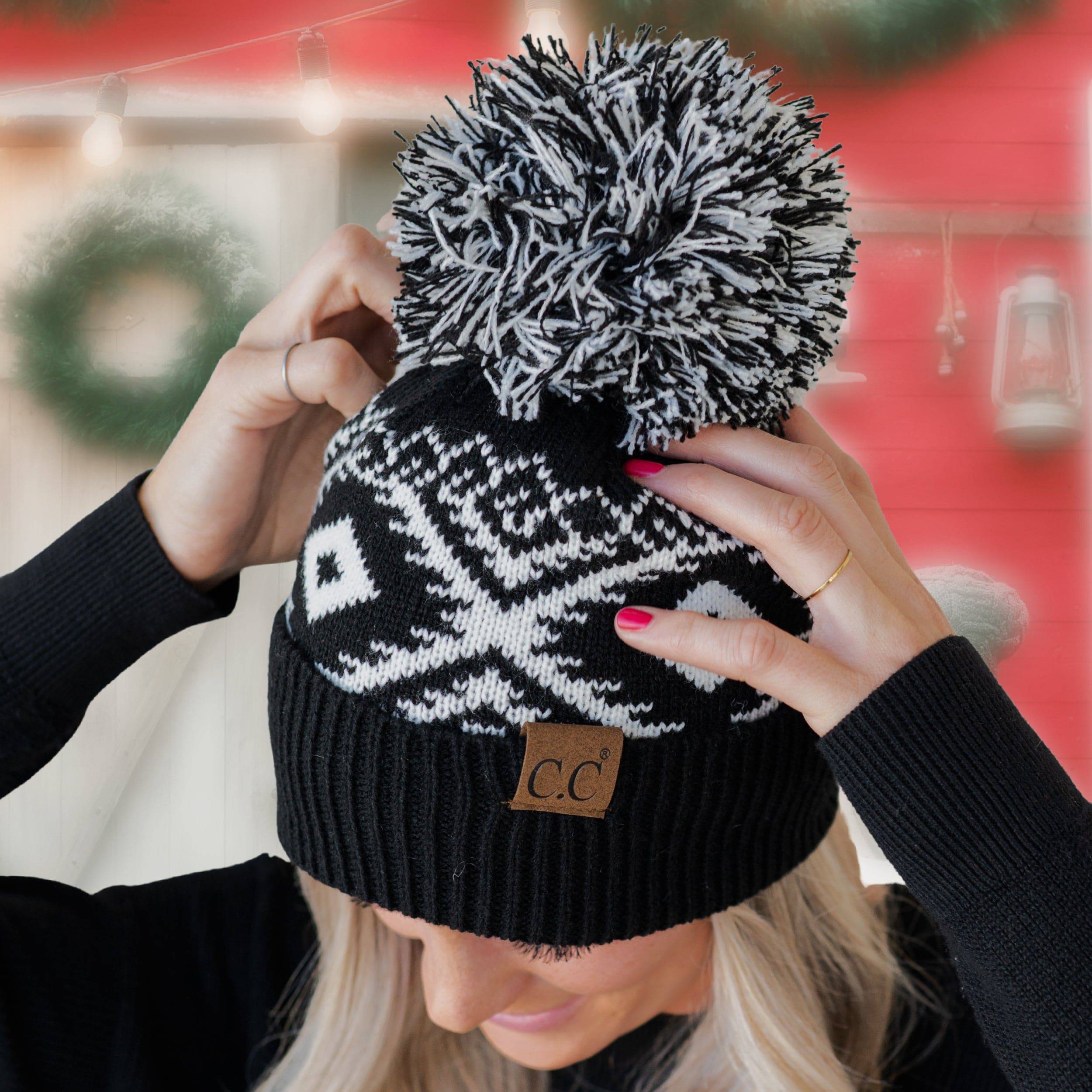 CC Western Print Beanie featuring a bold Aztec pattern and yarn pom, made from 100% acrylic for warmth and comfort.