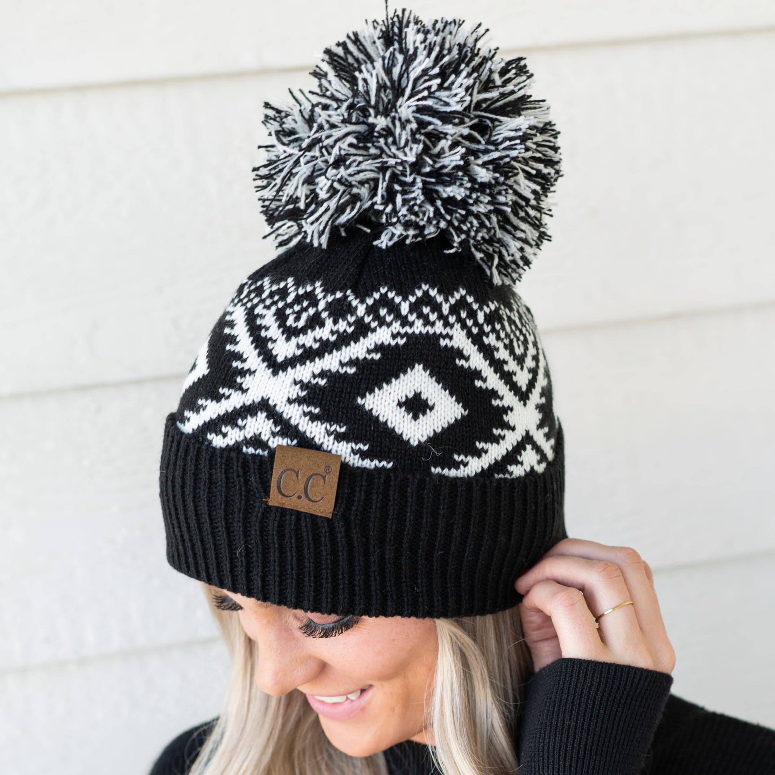 CC Western Print Beanie featuring a bold Aztec pattern and yarn pom, made from 100% acrylic for warmth and comfort.