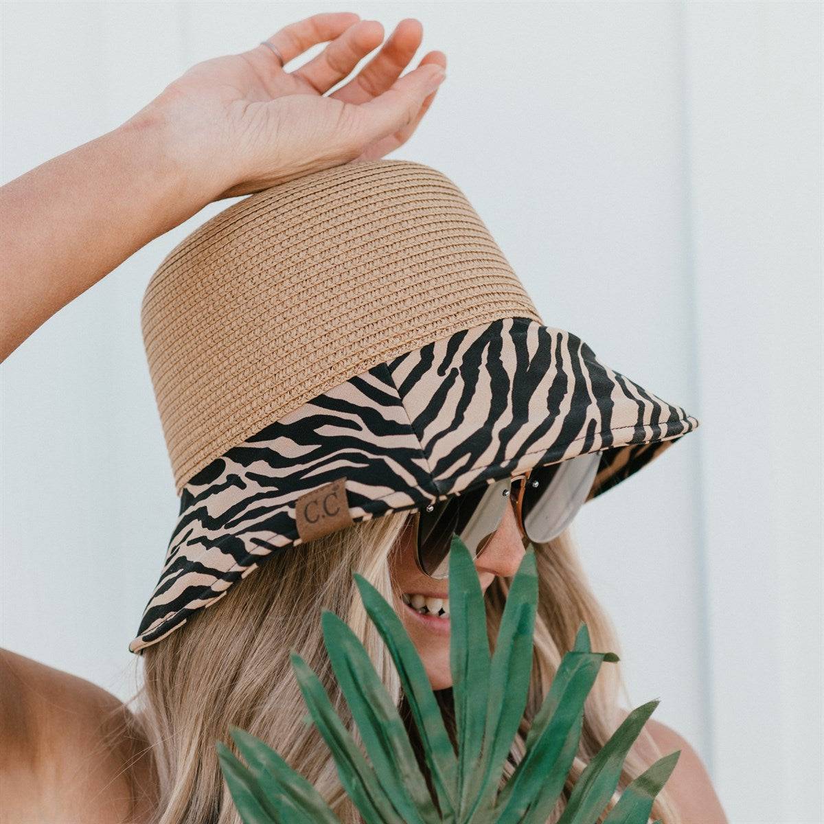 CC Zebra Print Straw Bucket Hat with adjustable inner band and stylish zebra pattern brim, perfect for sun protection and outdoor activities.