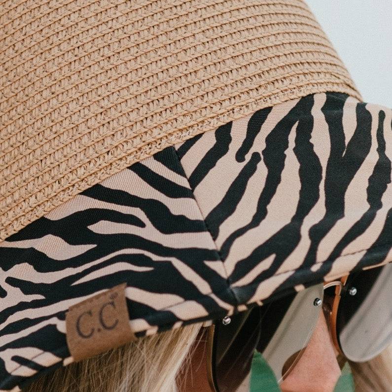 CC Zebra Print Straw Bucket Hat with adjustable inner band and stylish zebra pattern brim, perfect for sun protection and outdoor activities.