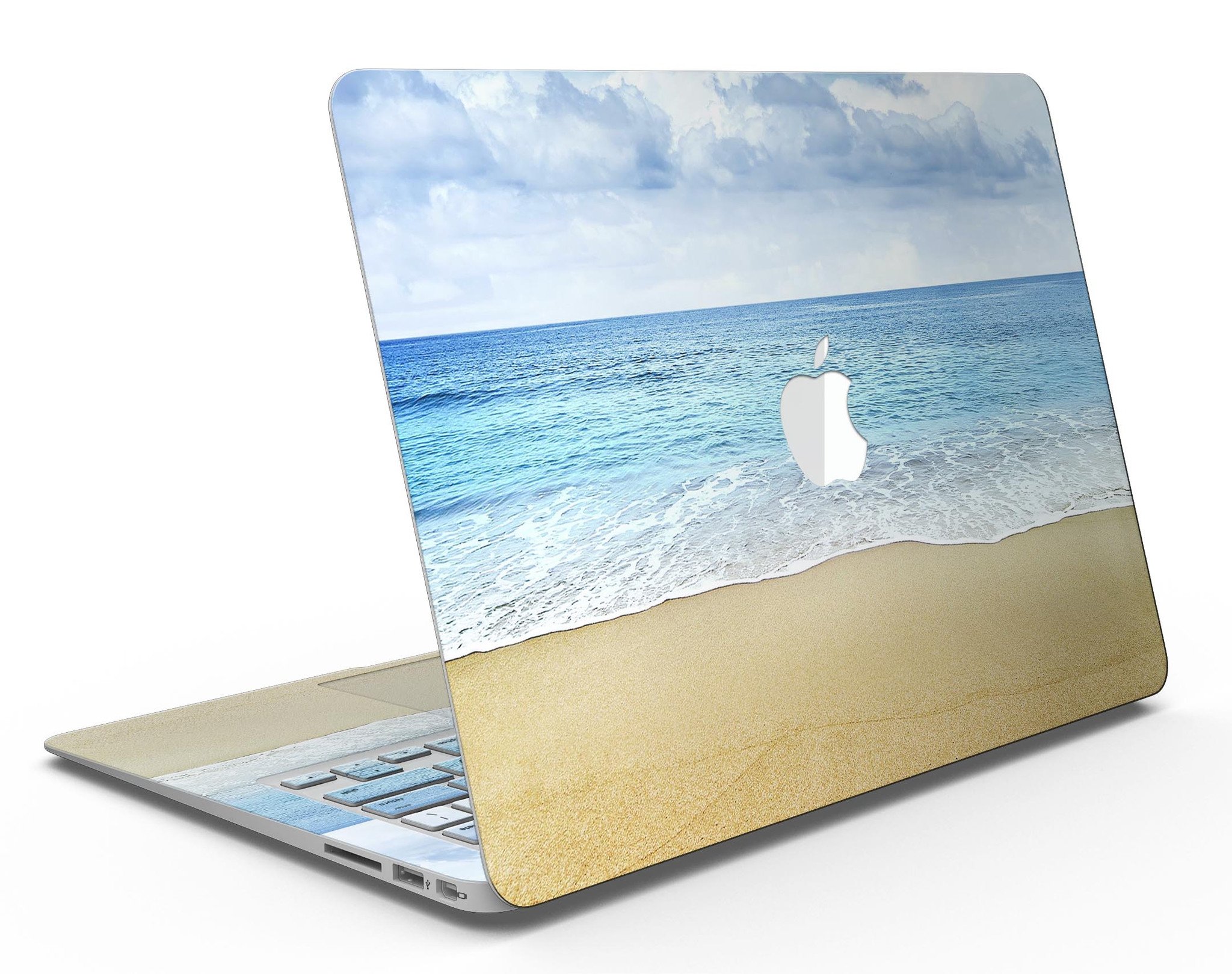 Calm Blue Sky and Sea Shore MacBook Air Skin Kit showcasing vibrant blue and sandy shore design on a sleek MacBook Air.