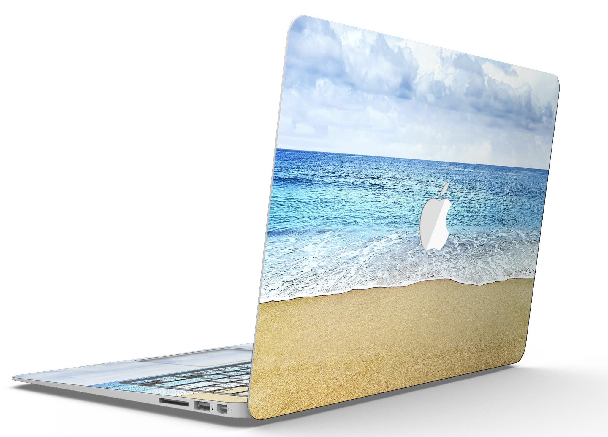 Calm Blue Sky and Sea Shore MacBook Air Skin Kit showcasing vibrant blue and sandy shore design on a sleek MacBook Air.