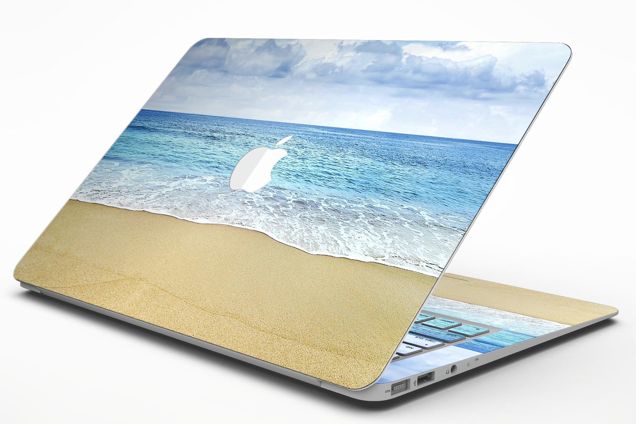 Calm Blue Sky and Sea Shore MacBook Air Skin Kit showcasing vibrant blue and sandy shore design on a sleek MacBook Air.