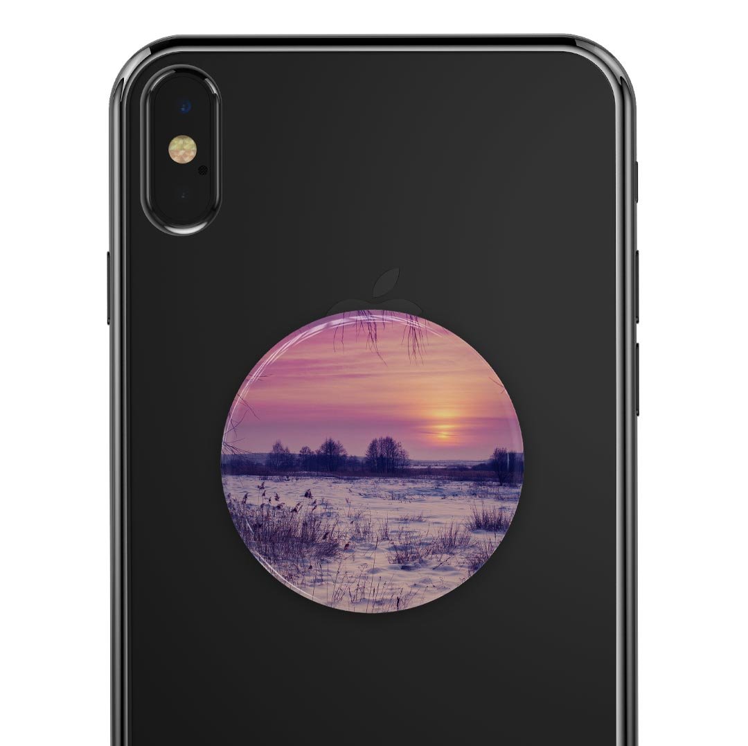 Calm Snowy Sunset Skin Kit for PopSockets, showcasing a serene snowy landscape design on a smartphone grip.