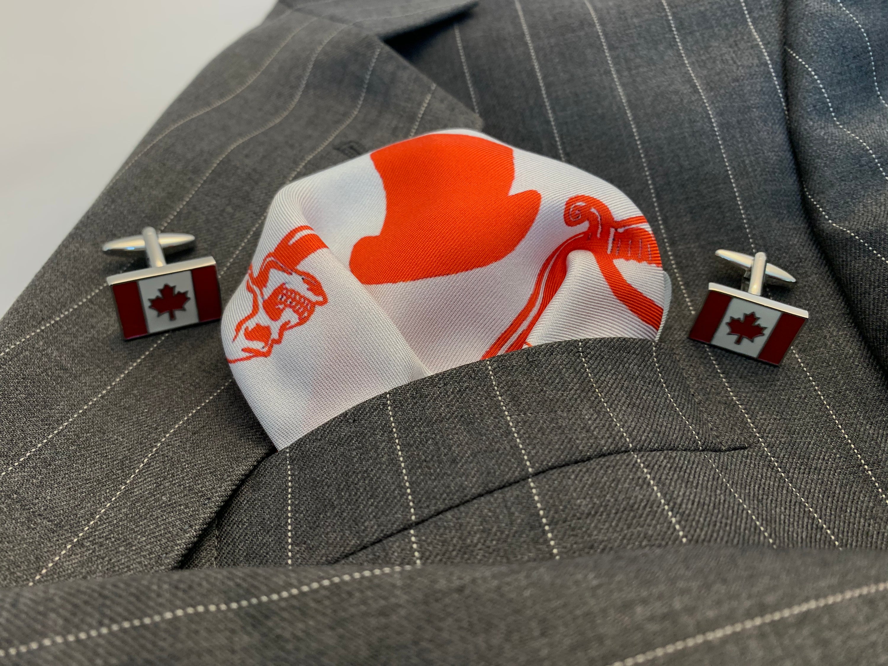 Canadian Rogue Pocket Square featuring a vibrant flag design in red, white, and Rogue colors, made from 100% silk.