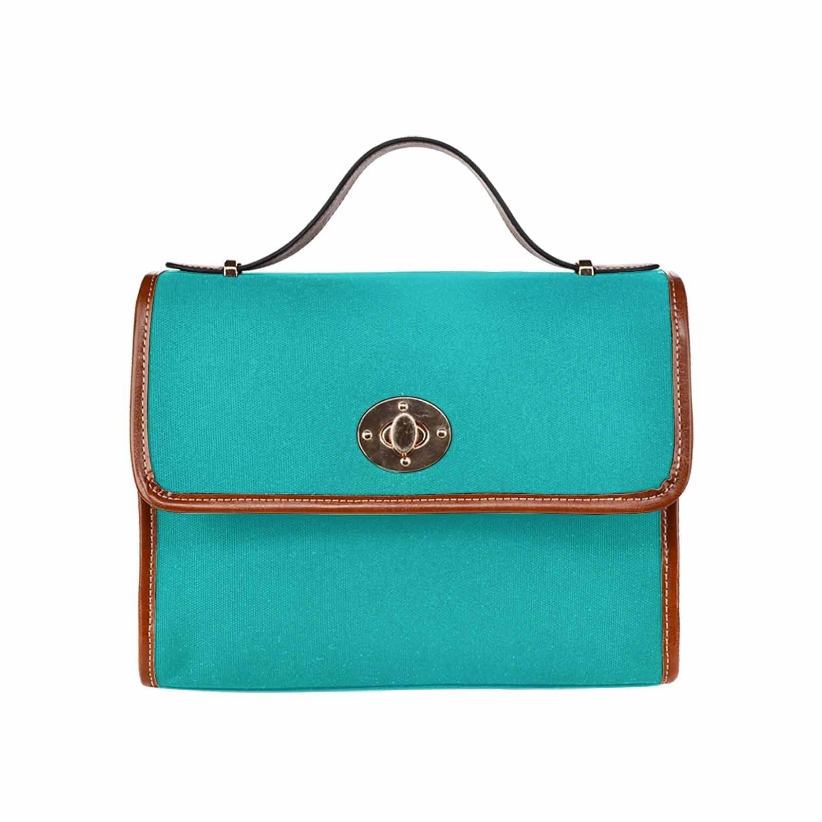 Stylish greenish blue canvas bag with brown shoulder strap, featuring two interior pockets and a zipper pocket.