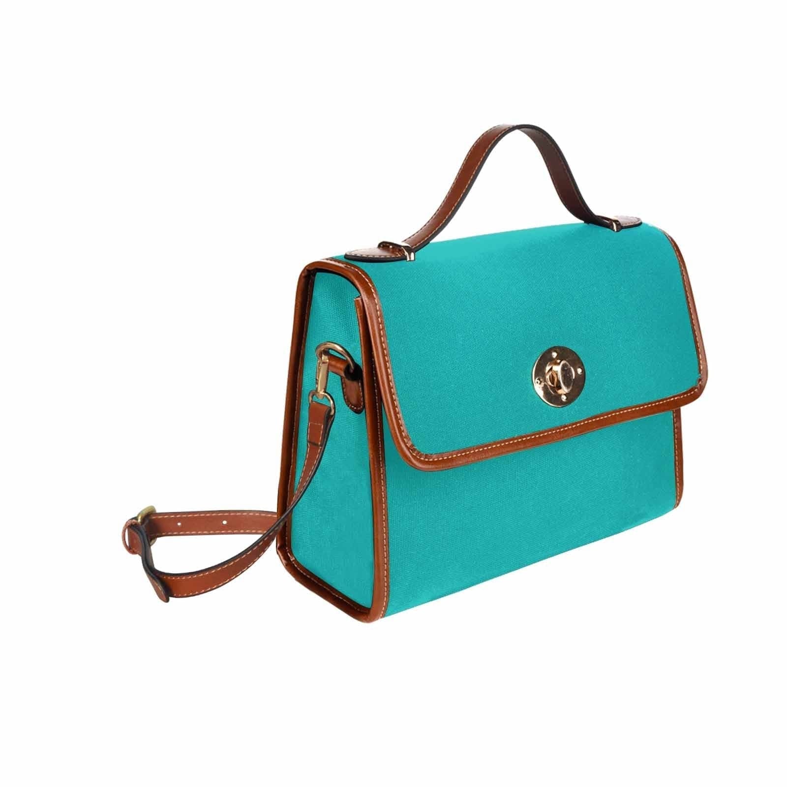 Stylish greenish blue canvas bag with brown shoulder strap, featuring two interior pockets and a zipper pocket.