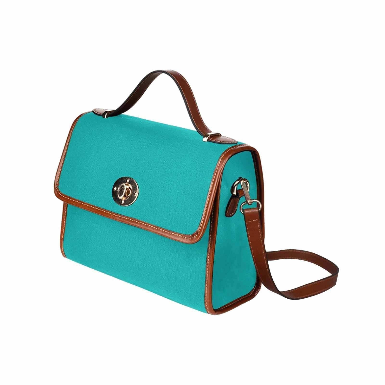 Stylish greenish blue canvas bag with brown shoulder strap, featuring two interior pockets and a zipper pocket.