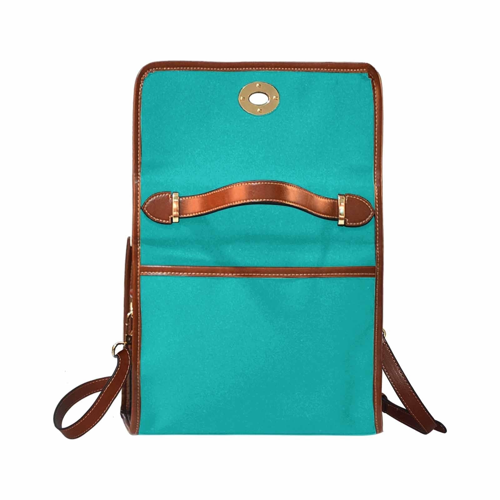 Stylish greenish blue canvas bag with brown shoulder strap, featuring two interior pockets and a zipper pocket.