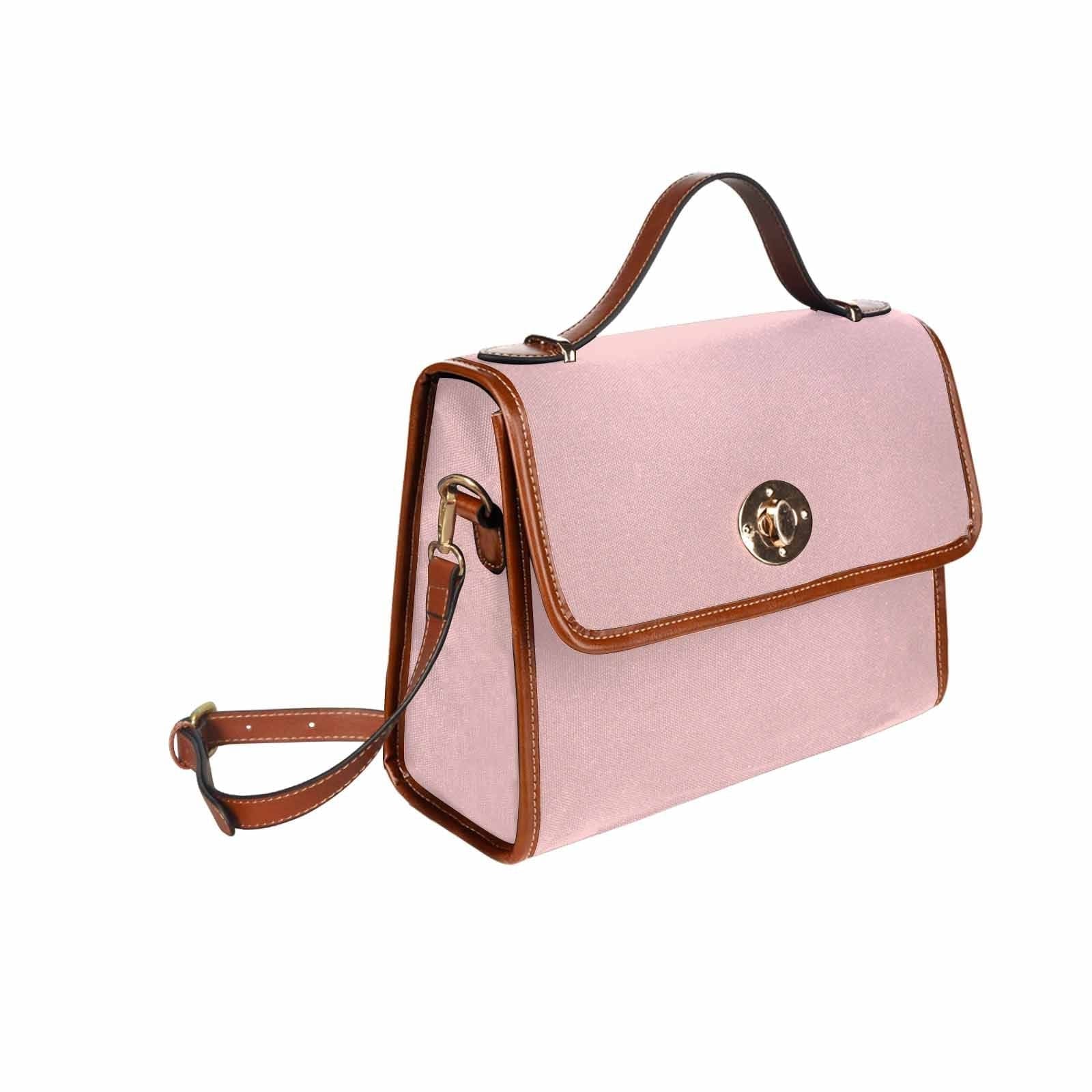 Canvas Bag in Rose Quartz Red with brown strap, featuring waterproof material and adjustable shoulder strap.