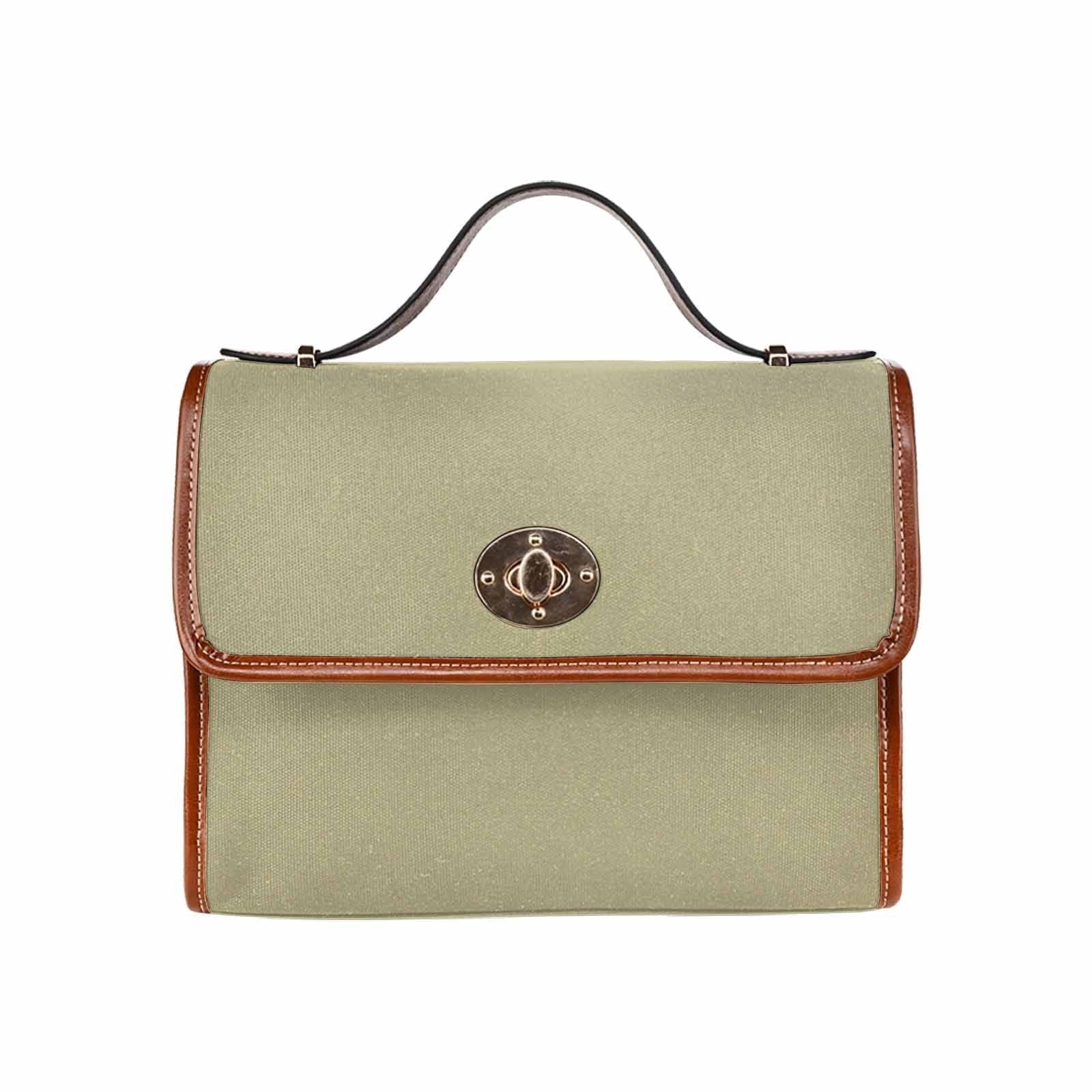 Sage green canvas bag with brown strap, featuring two interior pockets and a zipper pocket, perfect for versatile use.