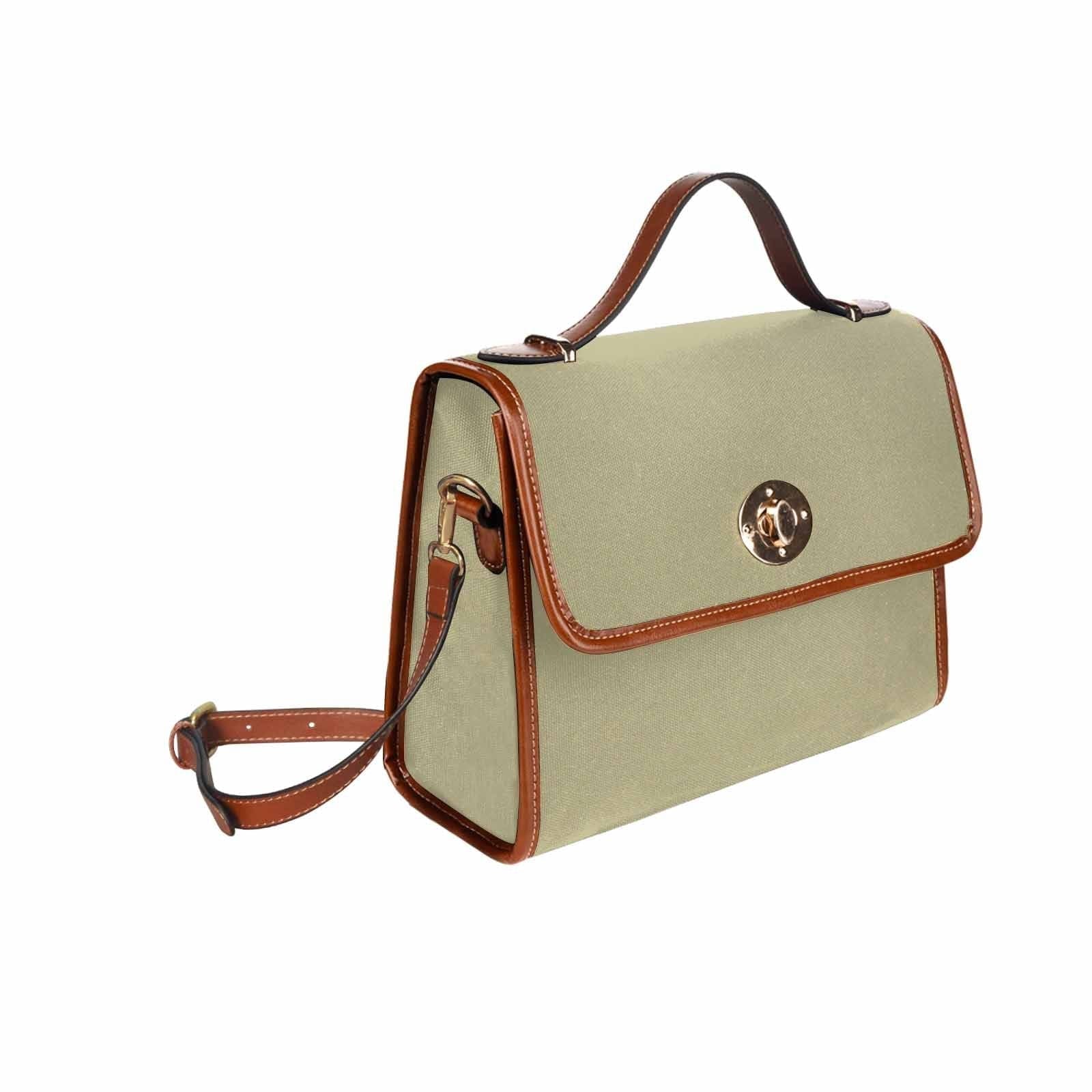 Sage green canvas bag with brown strap, featuring two interior pockets and a zipper pocket, perfect for versatile use.