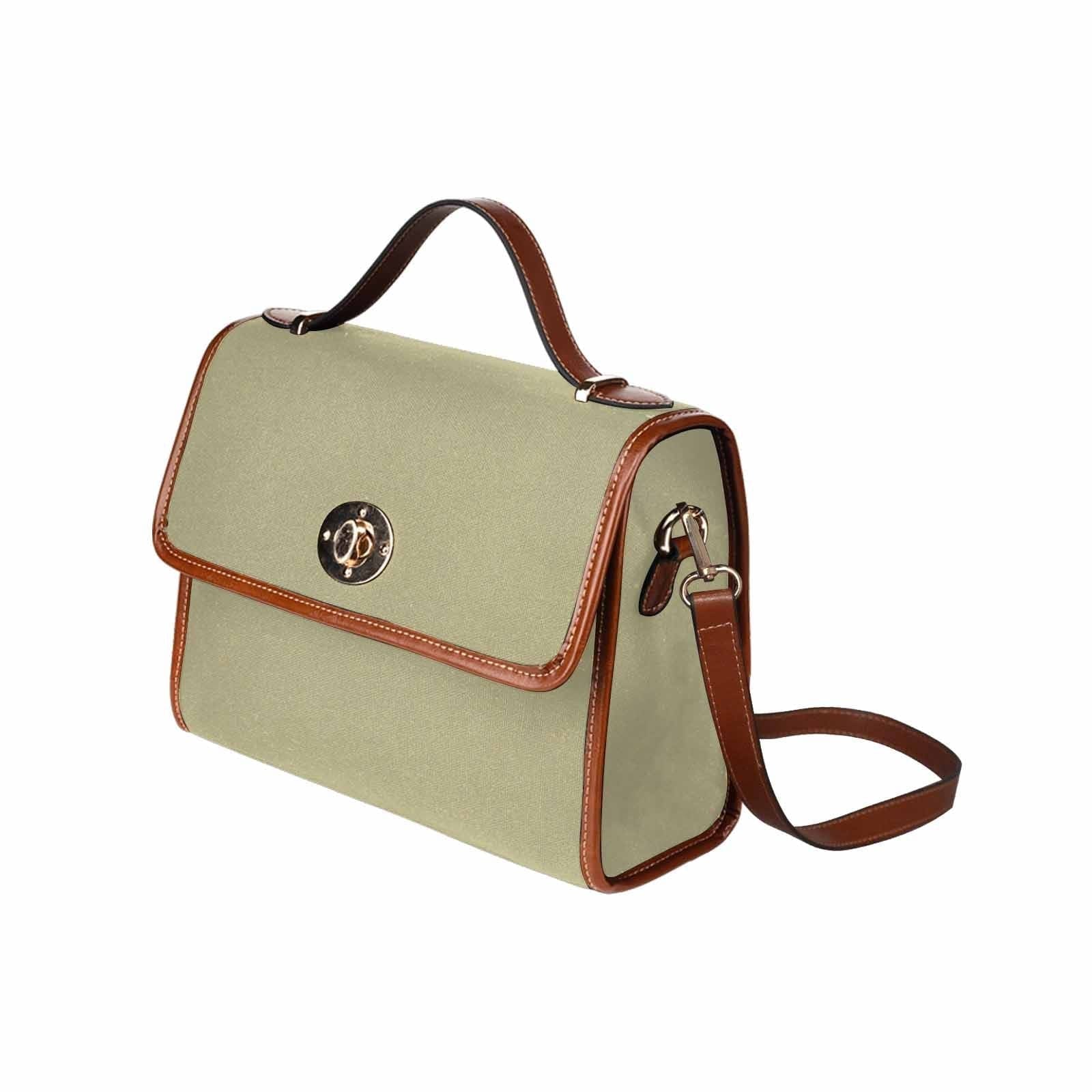 Sage green canvas bag with brown strap, featuring two interior pockets and a zipper pocket, perfect for versatile use.