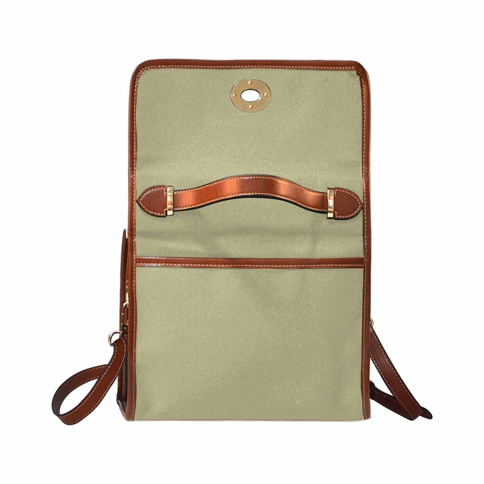 Sage green canvas bag with brown strap, featuring two interior pockets and a zipper pocket, perfect for versatile use.