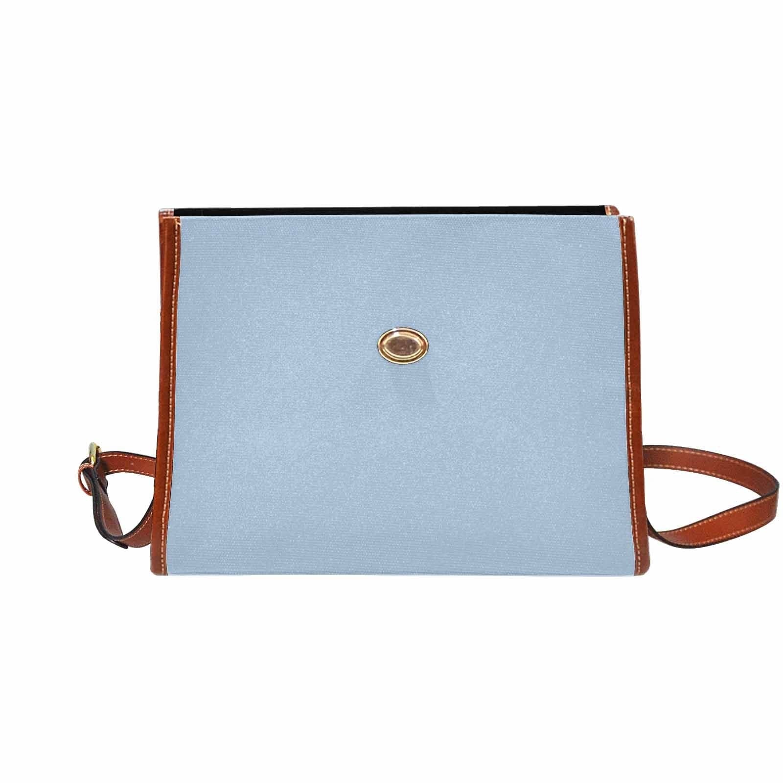 Serenity Blue Canvas Bag with brown strap, showcasing its waterproof material and stylish design.