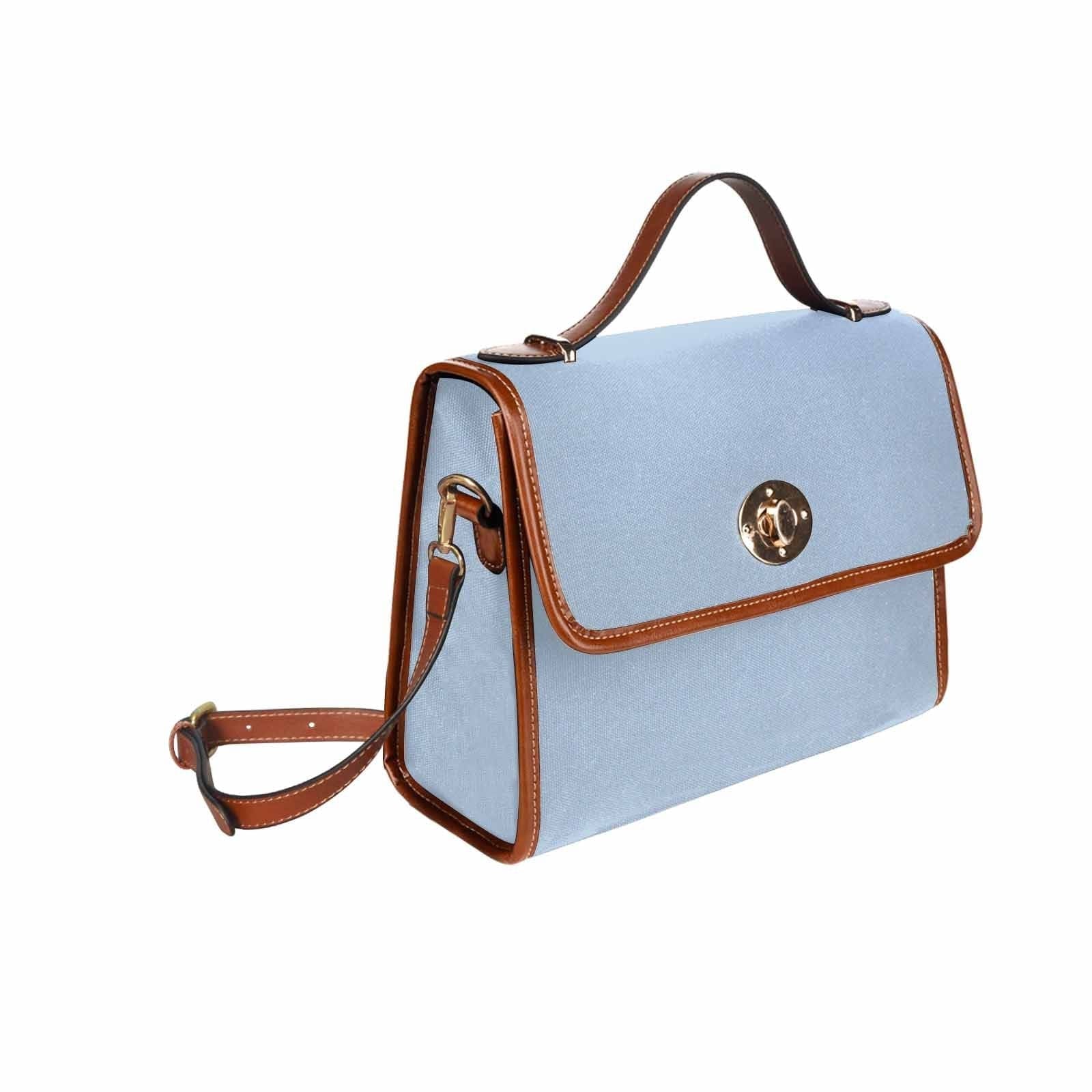 Serenity Blue Canvas Bag with brown strap, showcasing its waterproof material and stylish design.