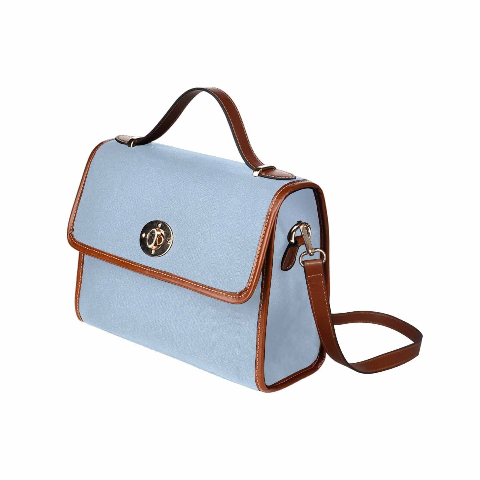 Serenity Blue Canvas Bag with brown strap, showcasing its waterproof material and stylish design.